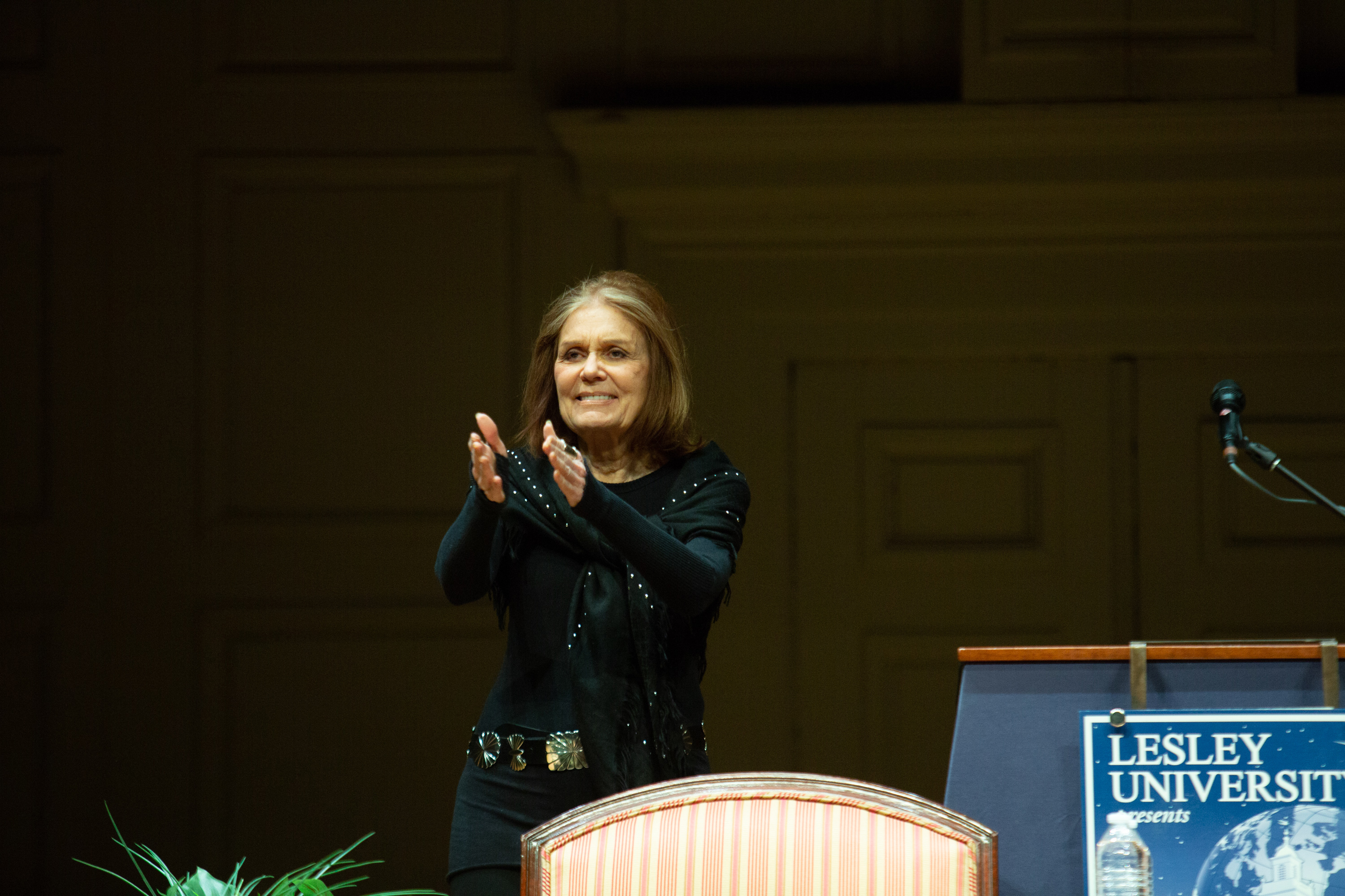 Gloria Steinem applauds on the Symphony Hall stage