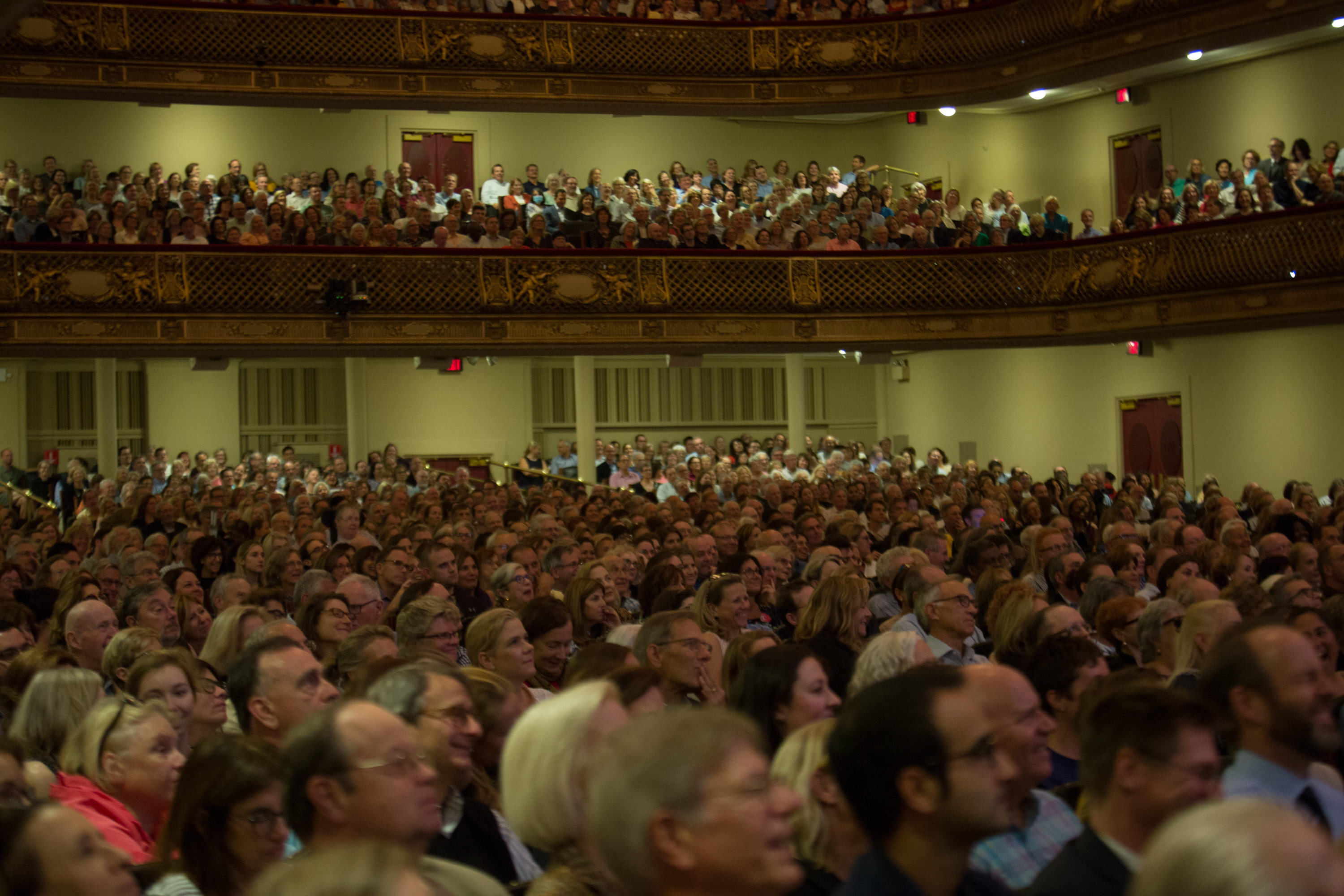 view of the audience in Symphony Hall listening to James Comey