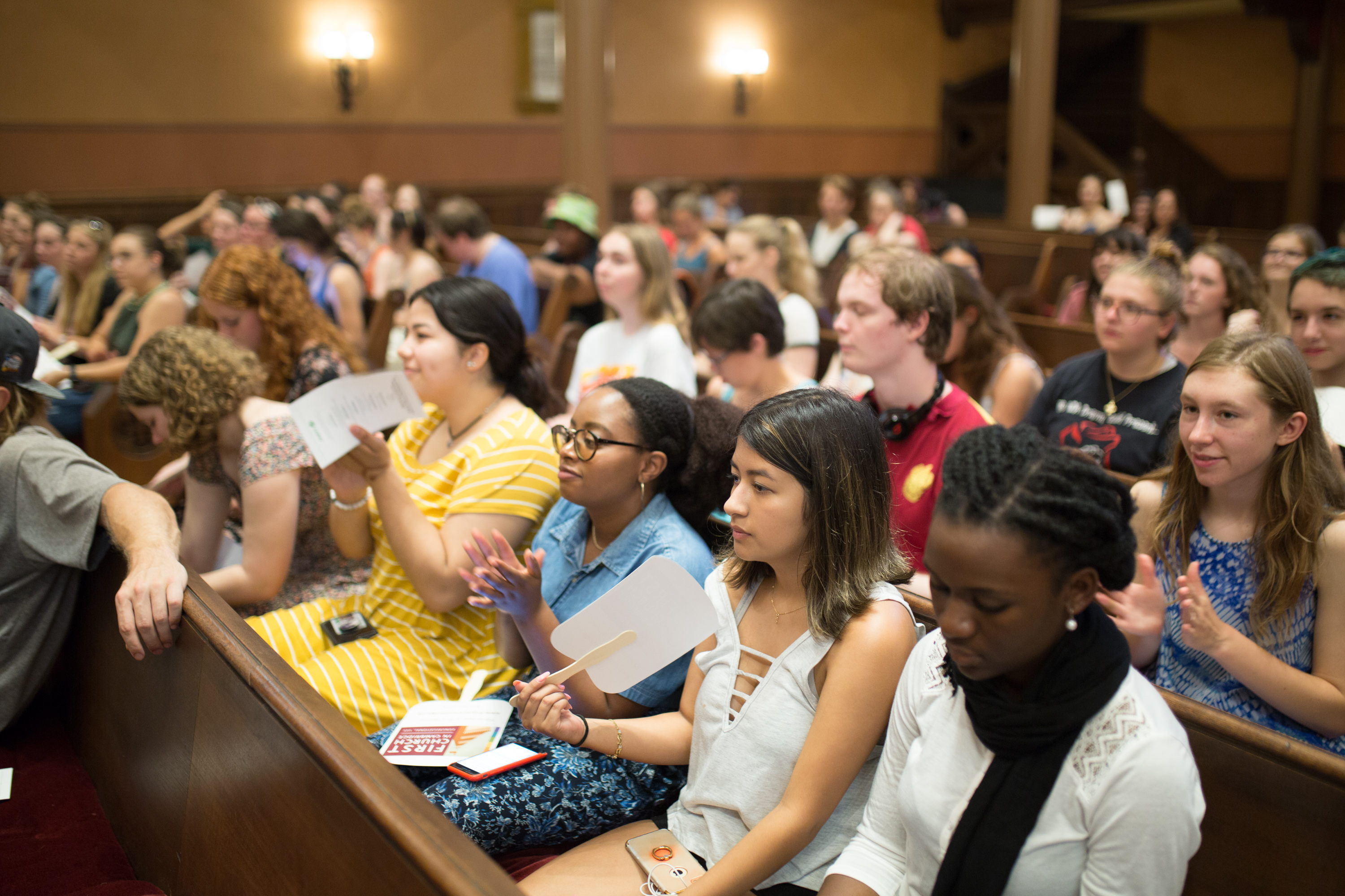 Students sitting in church pews at convocation