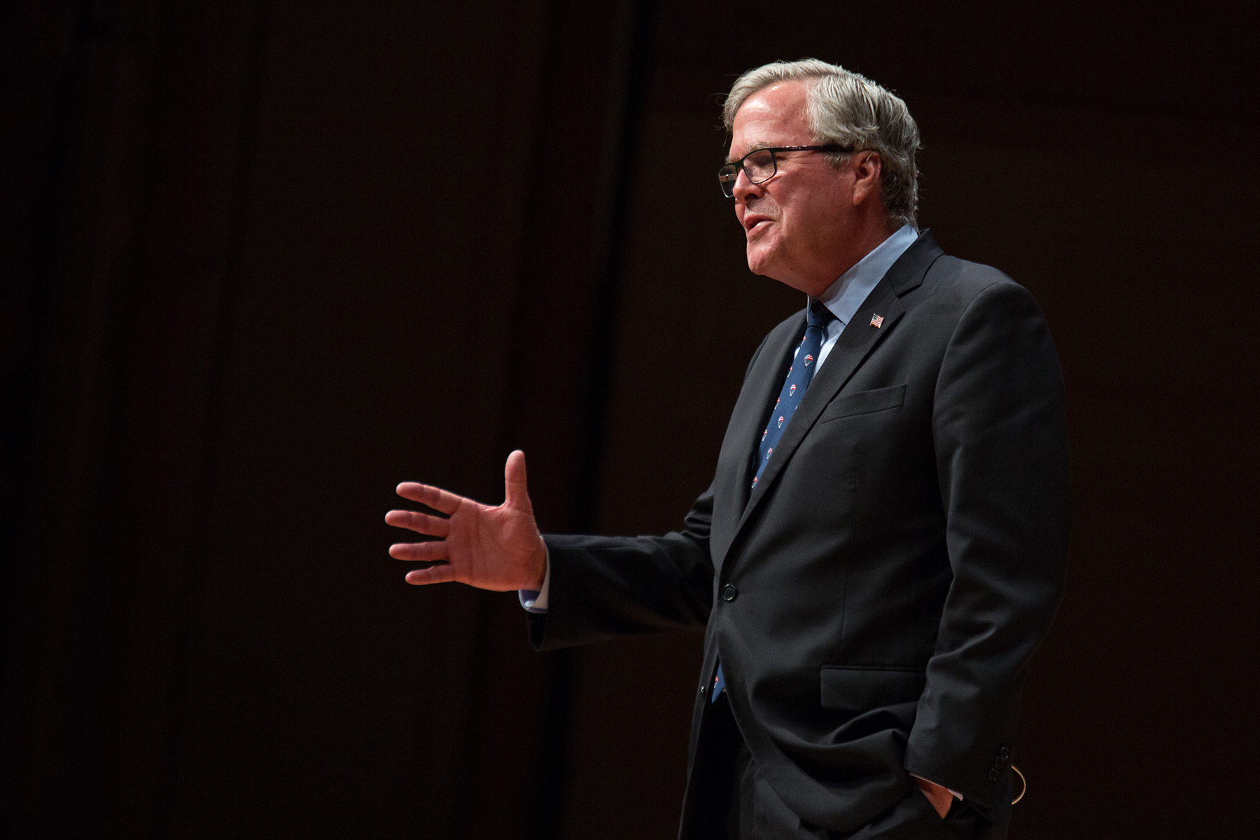 Jeb Bush gestures while he stands and delivers his lecture