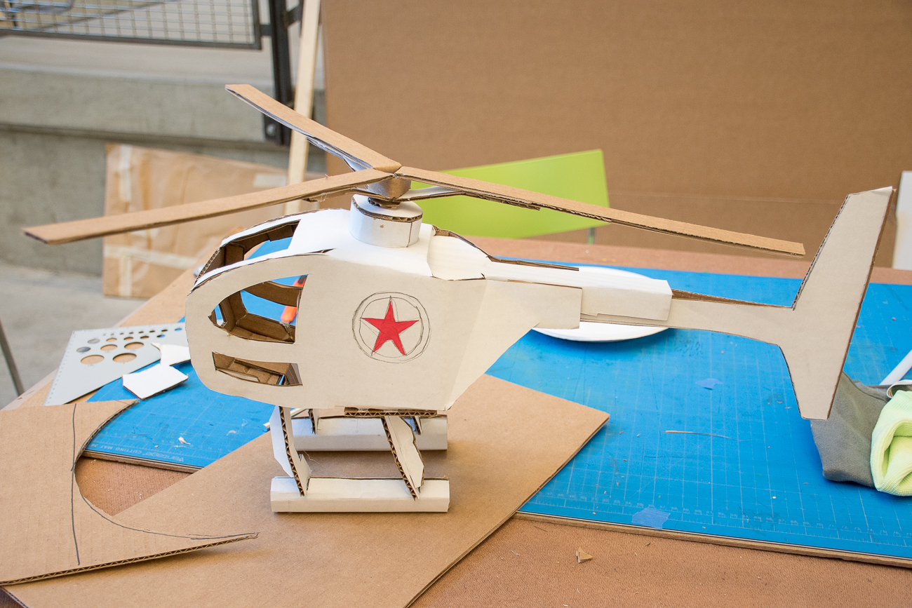 A helicopter made out of cardboard - it's white and has a star on the side.