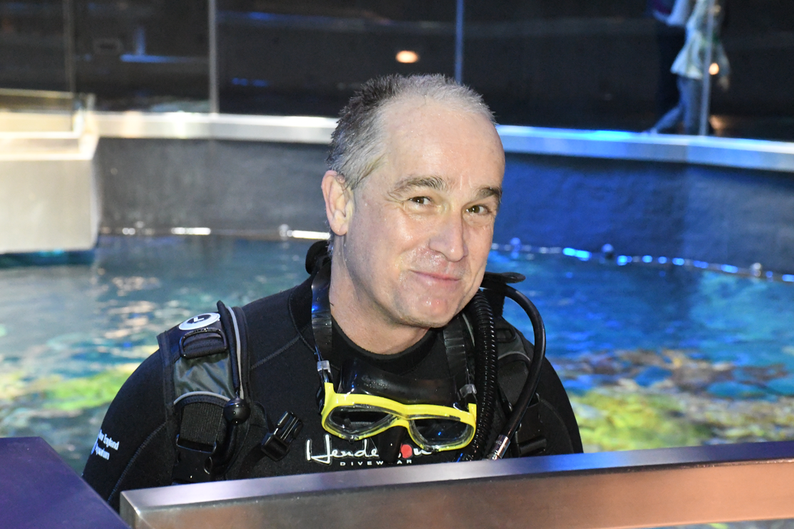 Threshold director Ernst VanBergeijk dives in the ocean tank at the New England Aquarium.