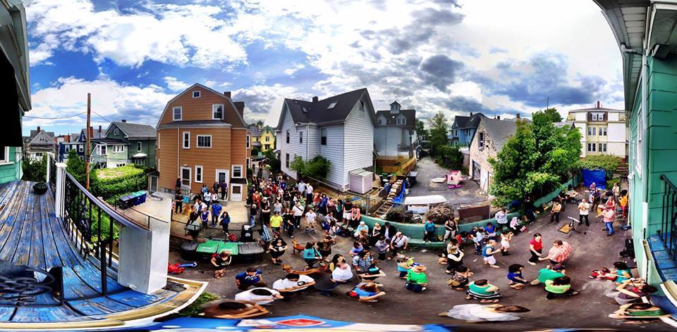 People celebrating outside on porches and walking around outside.