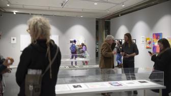 People in the Roberts Gallery during an exhibition looking at artwork