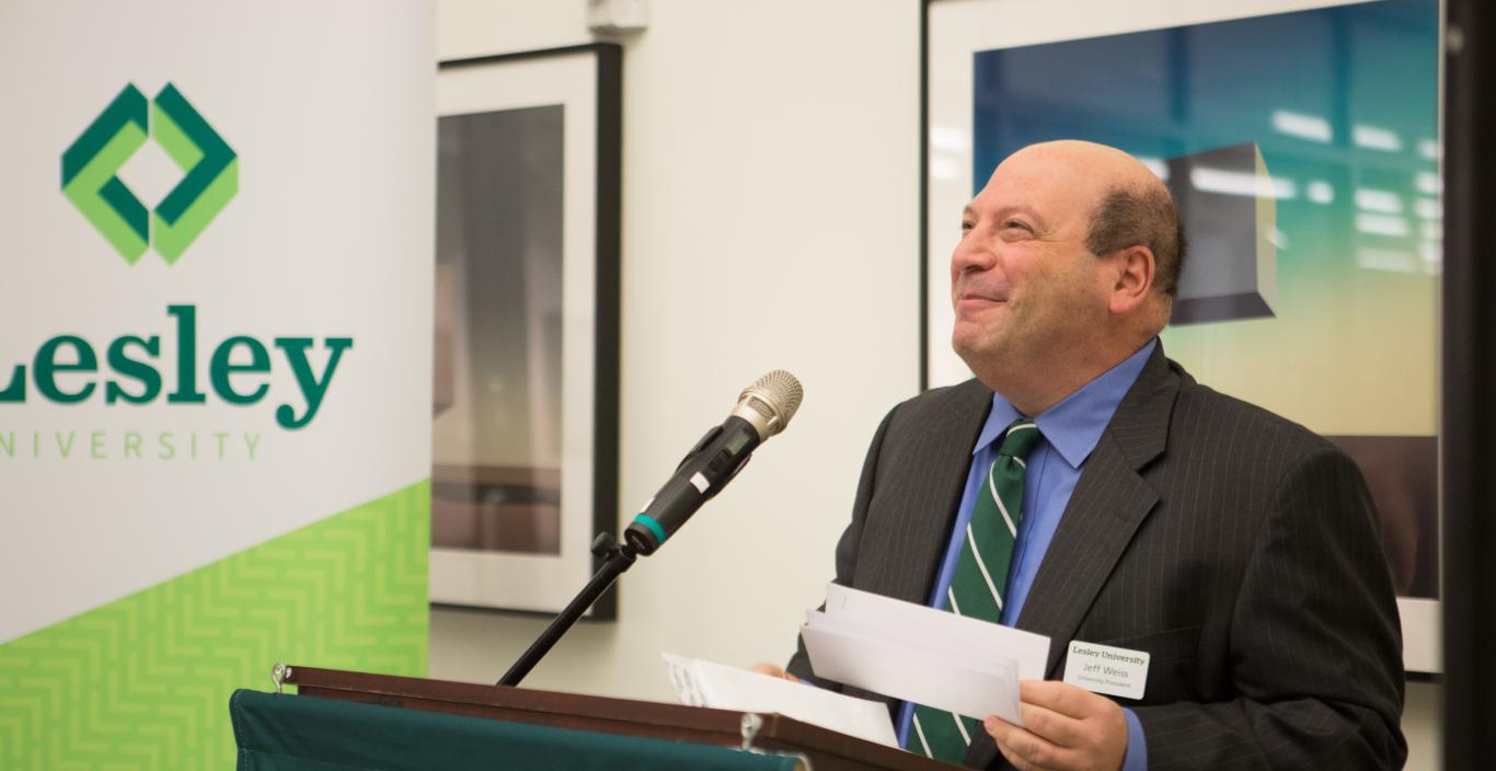 President Jeff Weiss at the podium at Lesley University