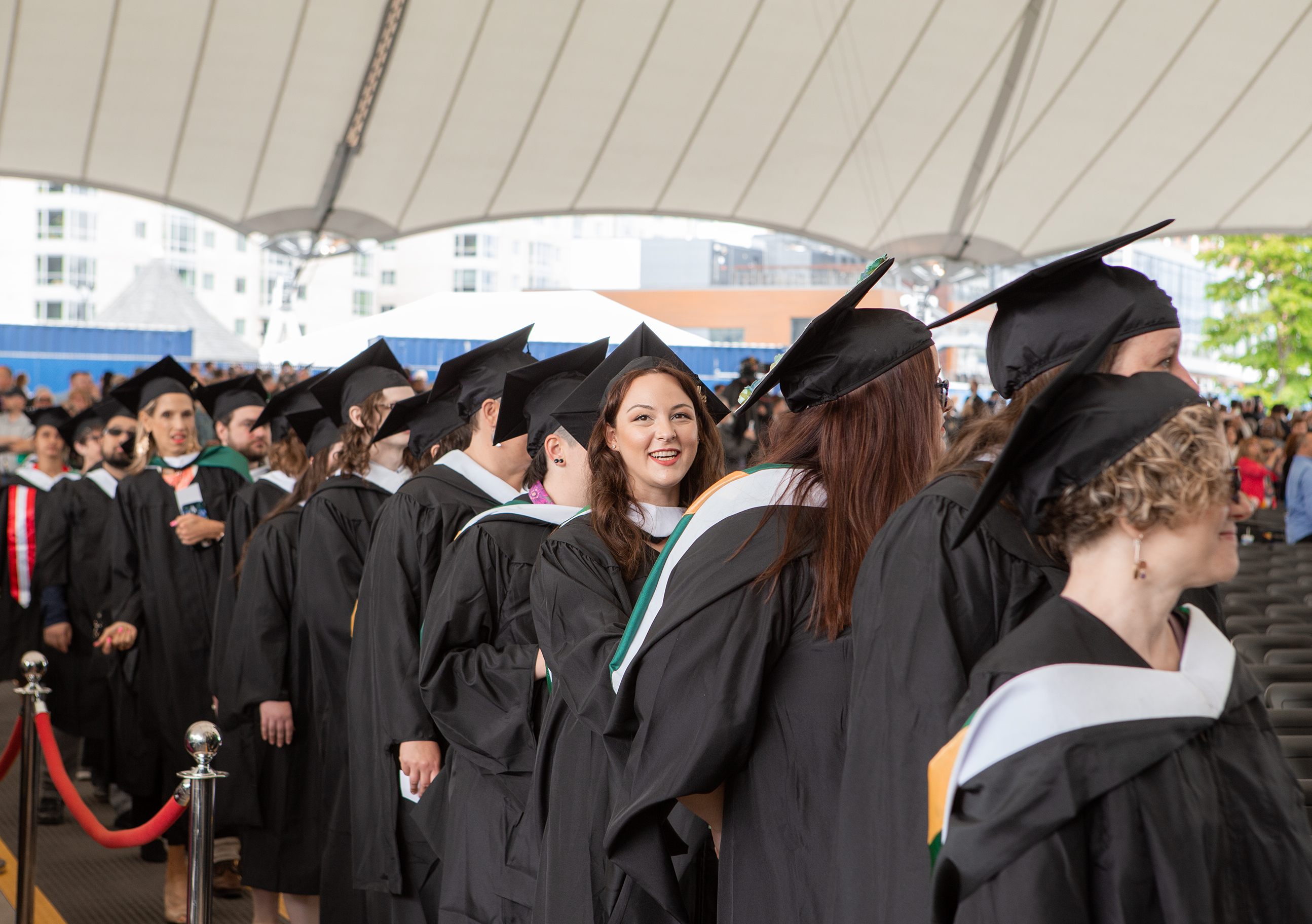 Lesley graduate waiting in line to be seated.