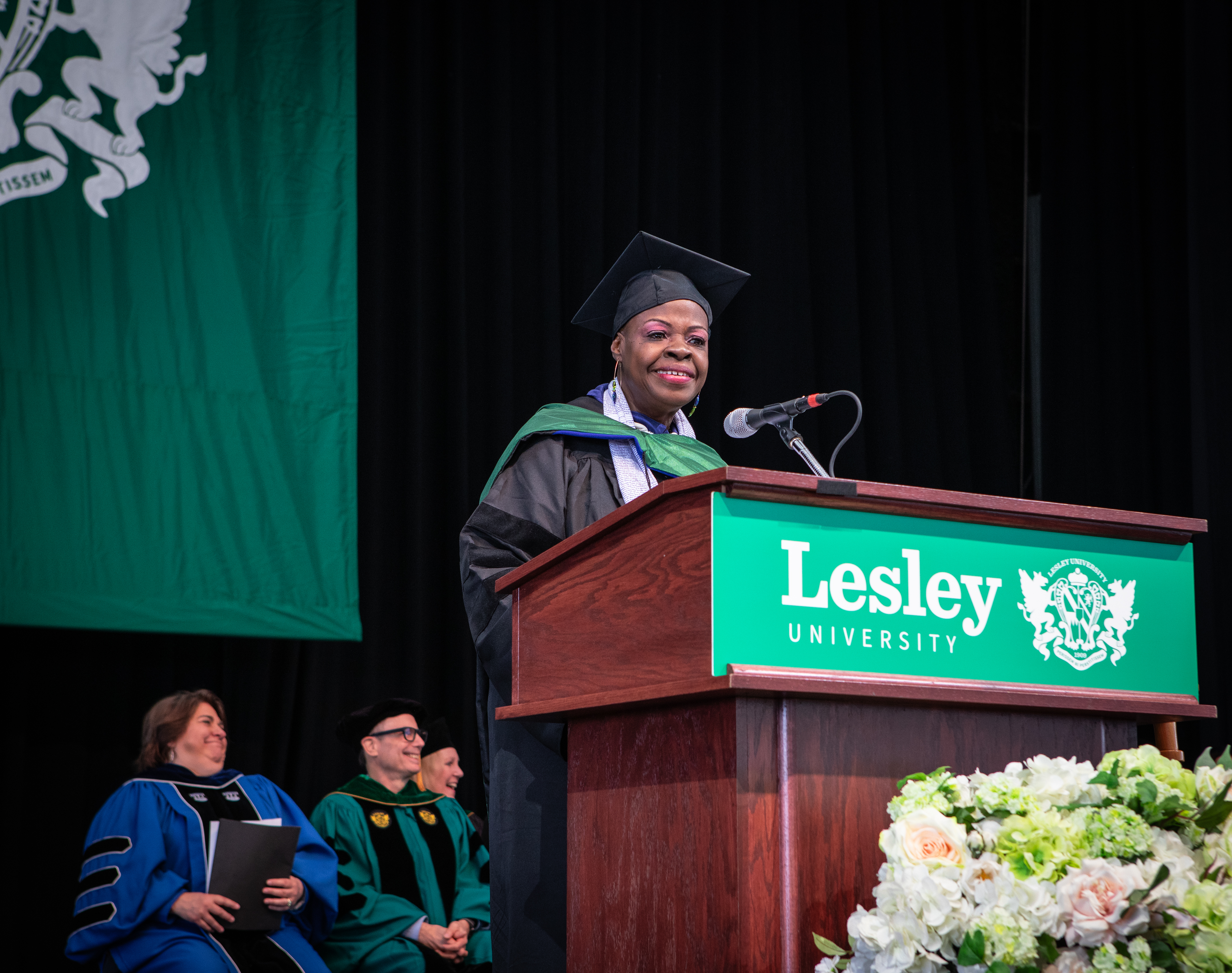 Dr. Barbara Bethea speaks at podium at Lesley's 2024 commencement ceremony.