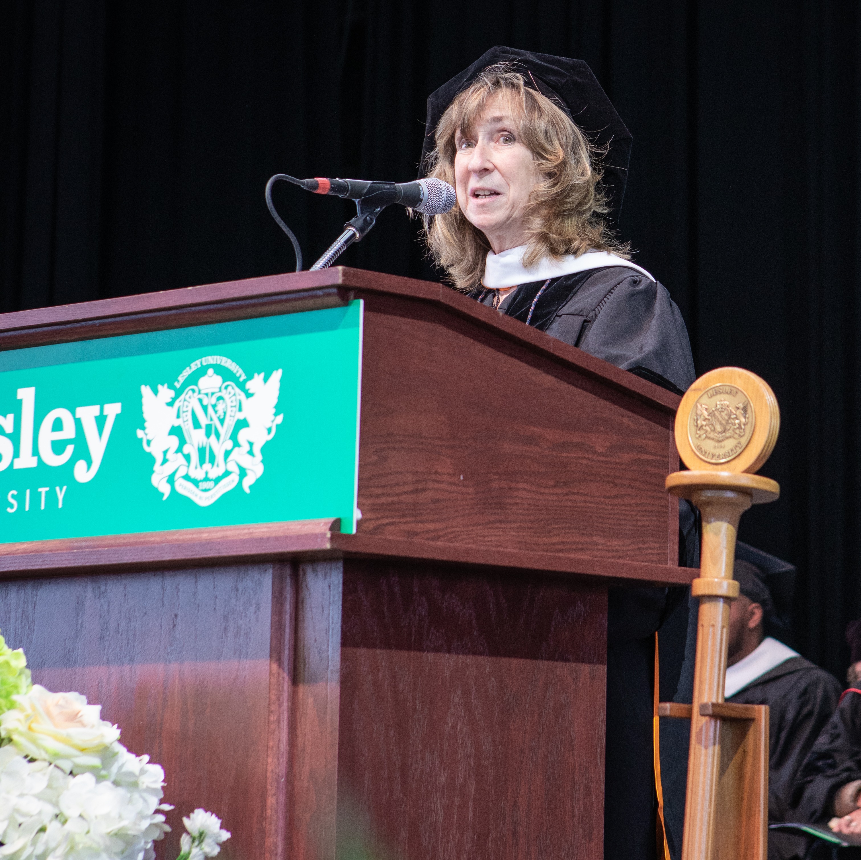Sy Montgomery speaks at podium during Lesley's 2024 commencement ceremony.