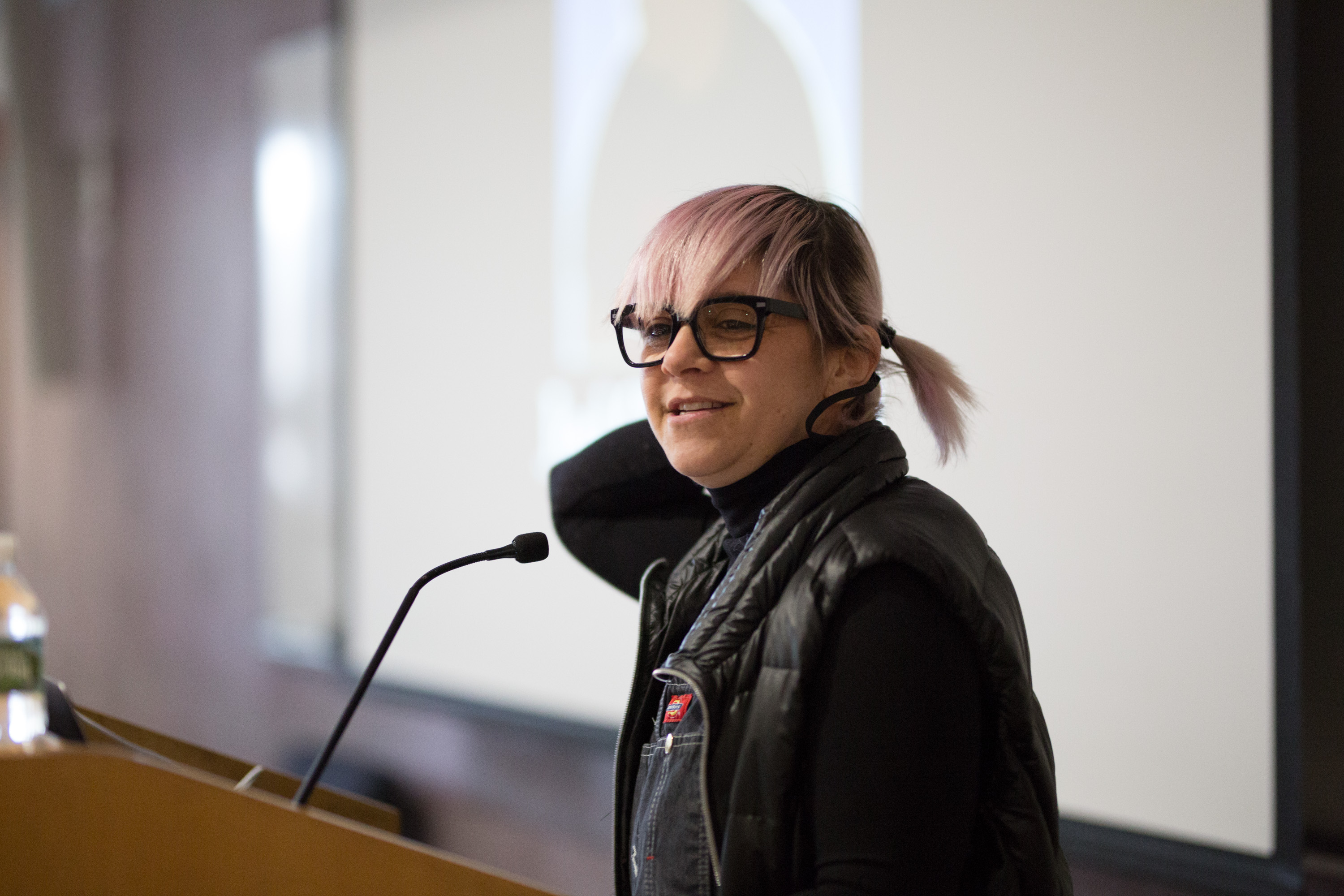 Illustration professor Louisa Bertman speaks at the podium