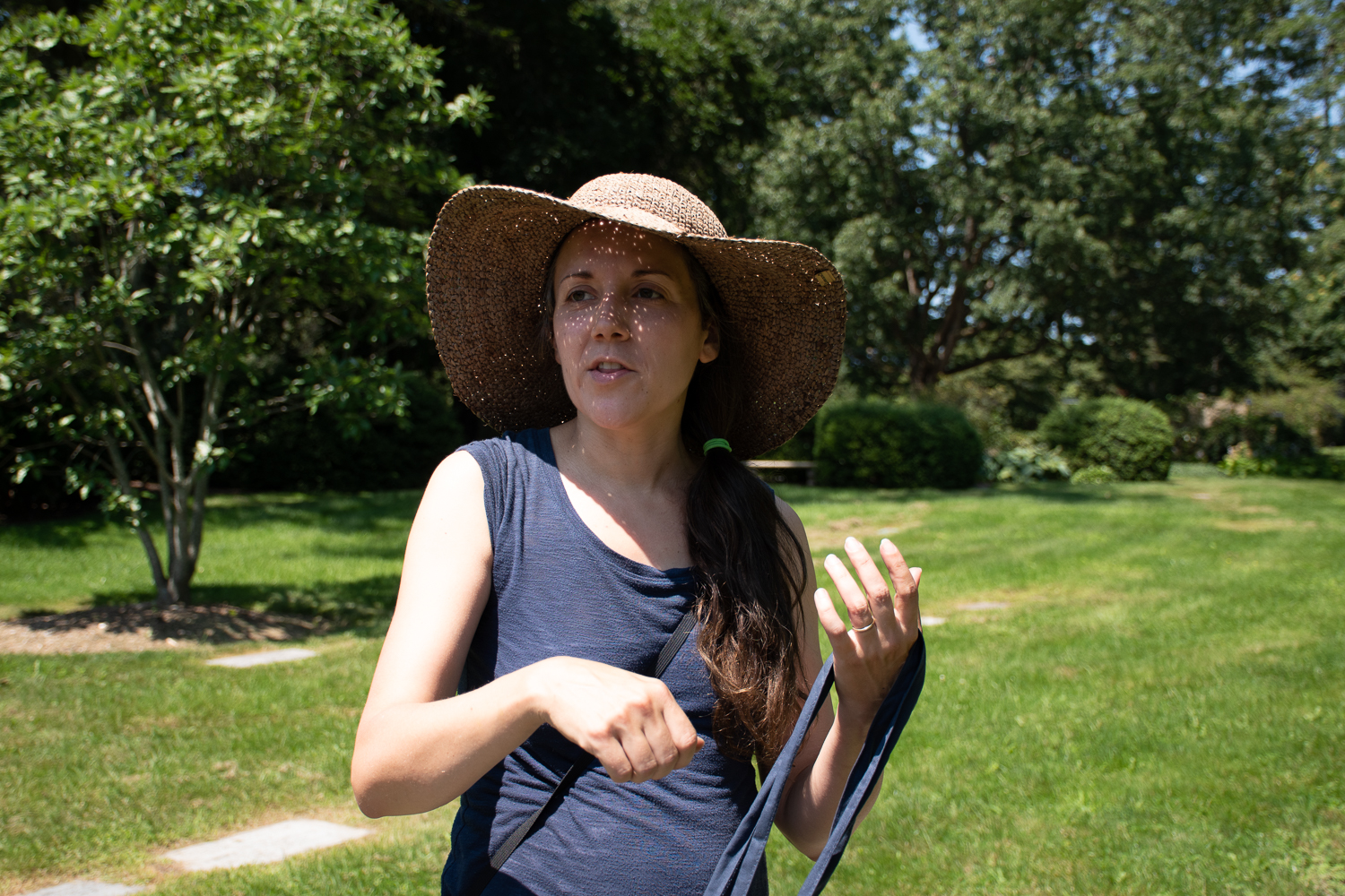 Amy Mertl wearing a sunhat and speaking outside.