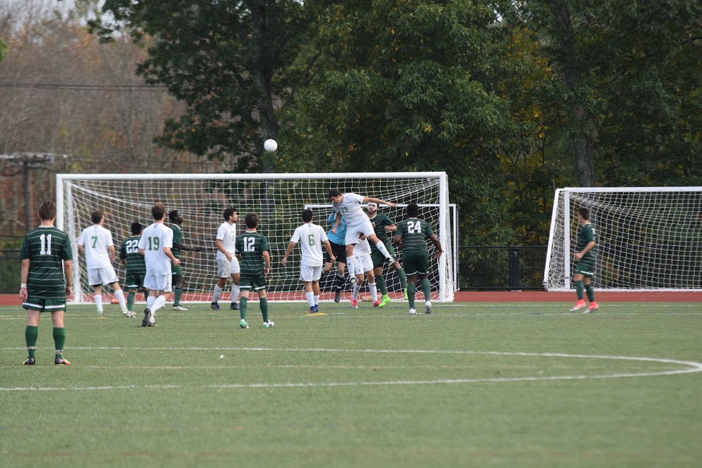 Men's soccer playoff game with net in the background. 