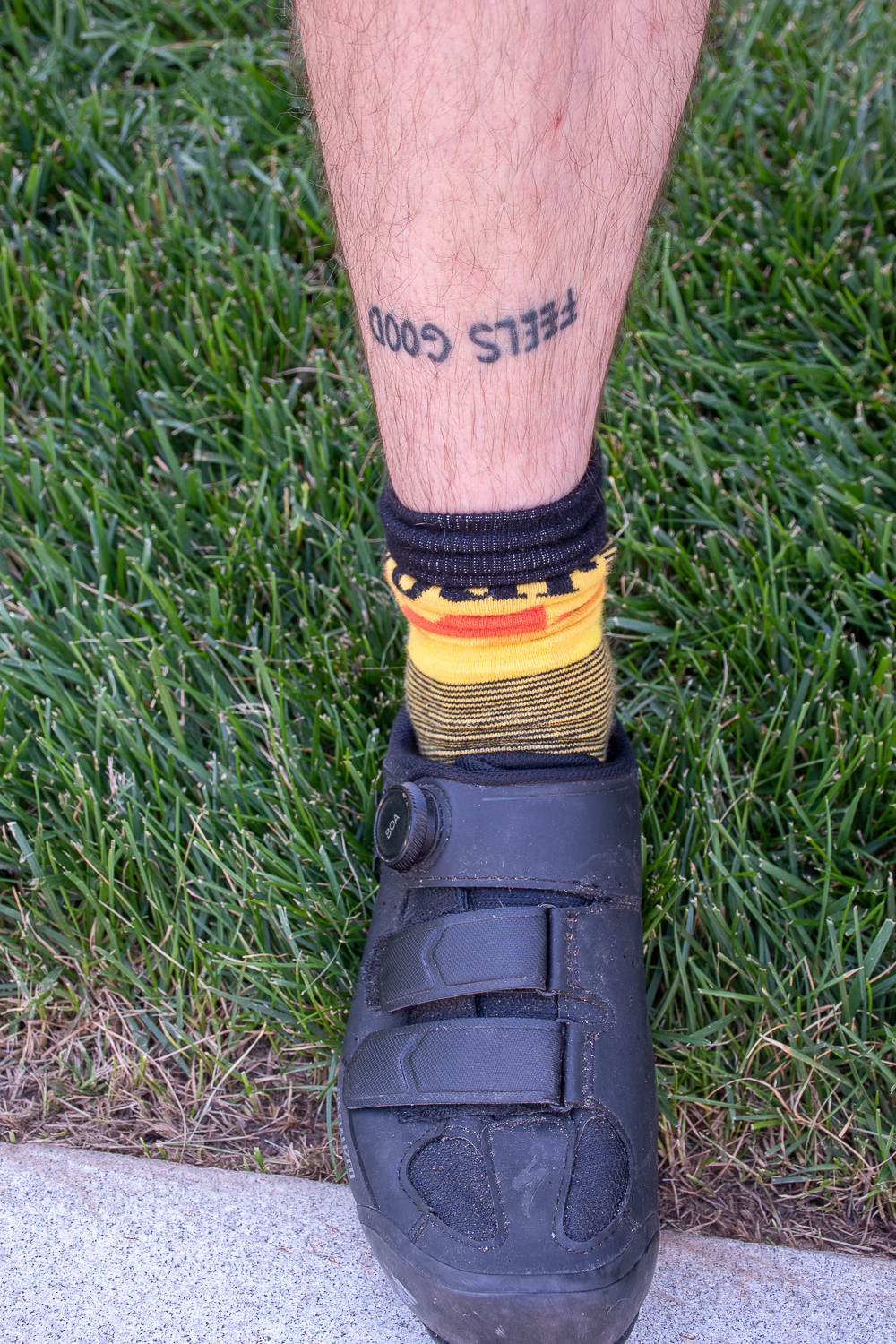 Image of Brendan Walsh's bare shin with tattoo that reads "feels good."