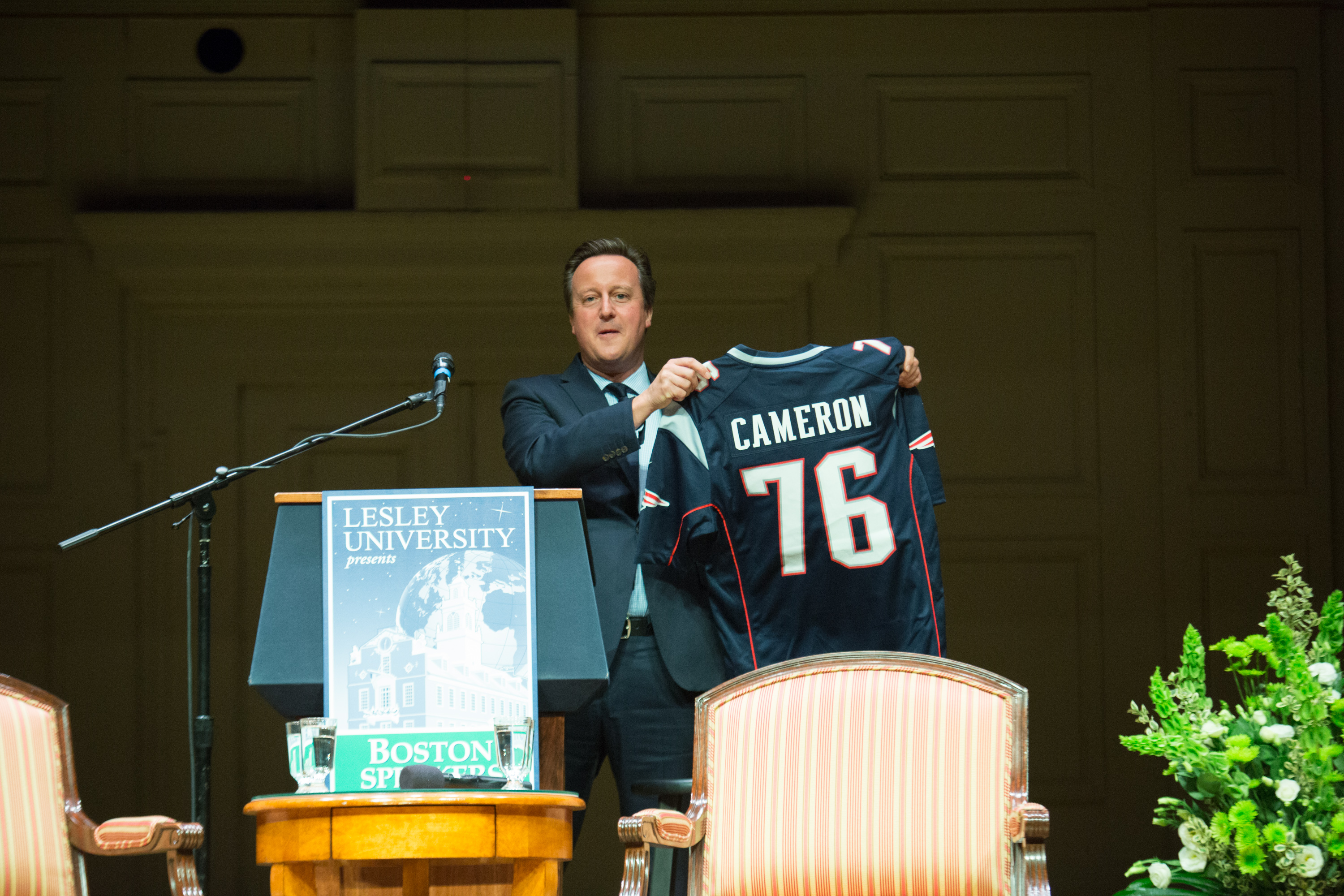 David Cameron holding up Patriots Football Jersey
