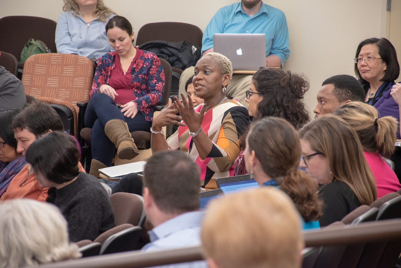 Sandra Walker speaks in a crowd of people.