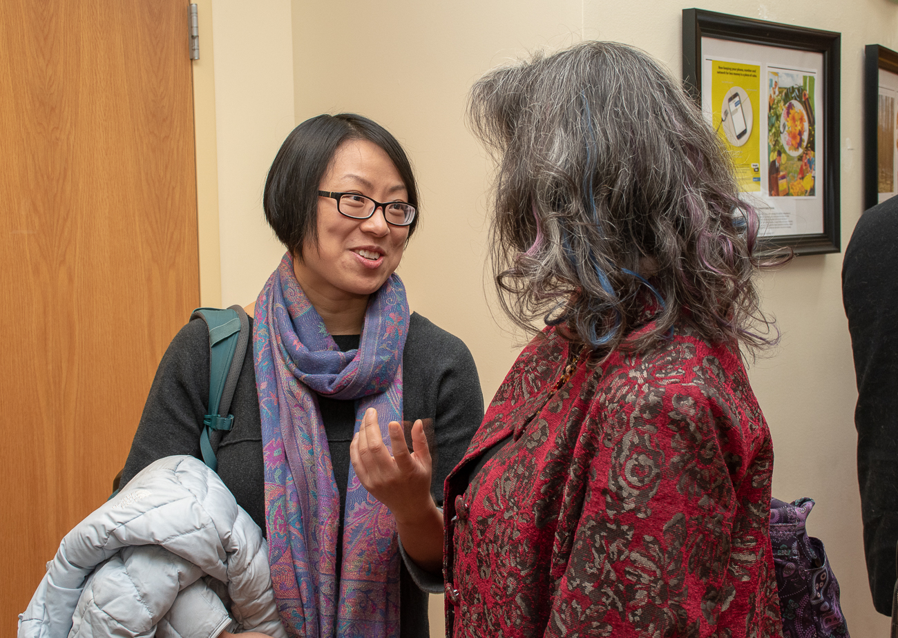 Assistant Professor Peiwei Li speaks to a colleague