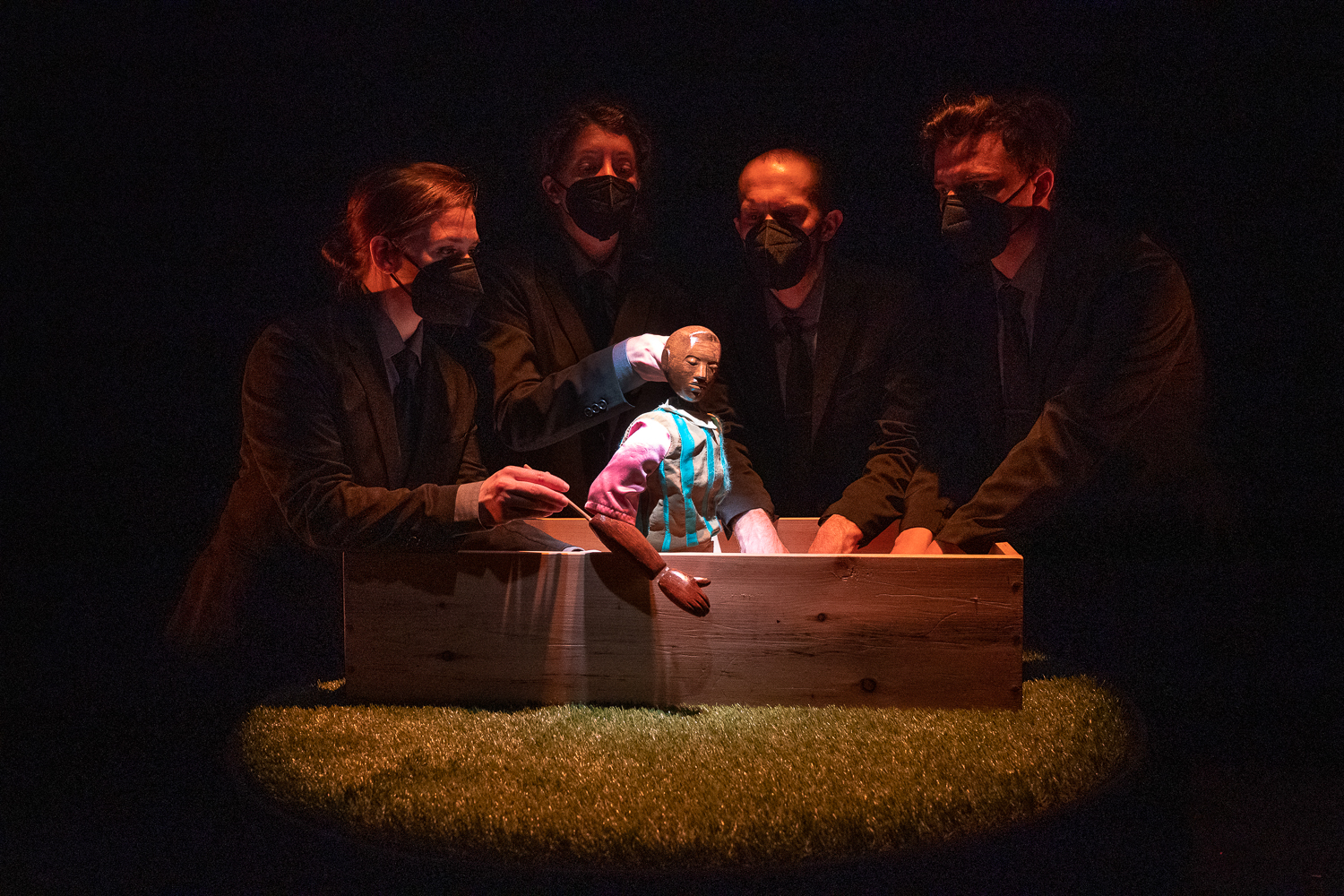 Image from "Fly Away" puppet in a box surrounded by puppeteers on a stage