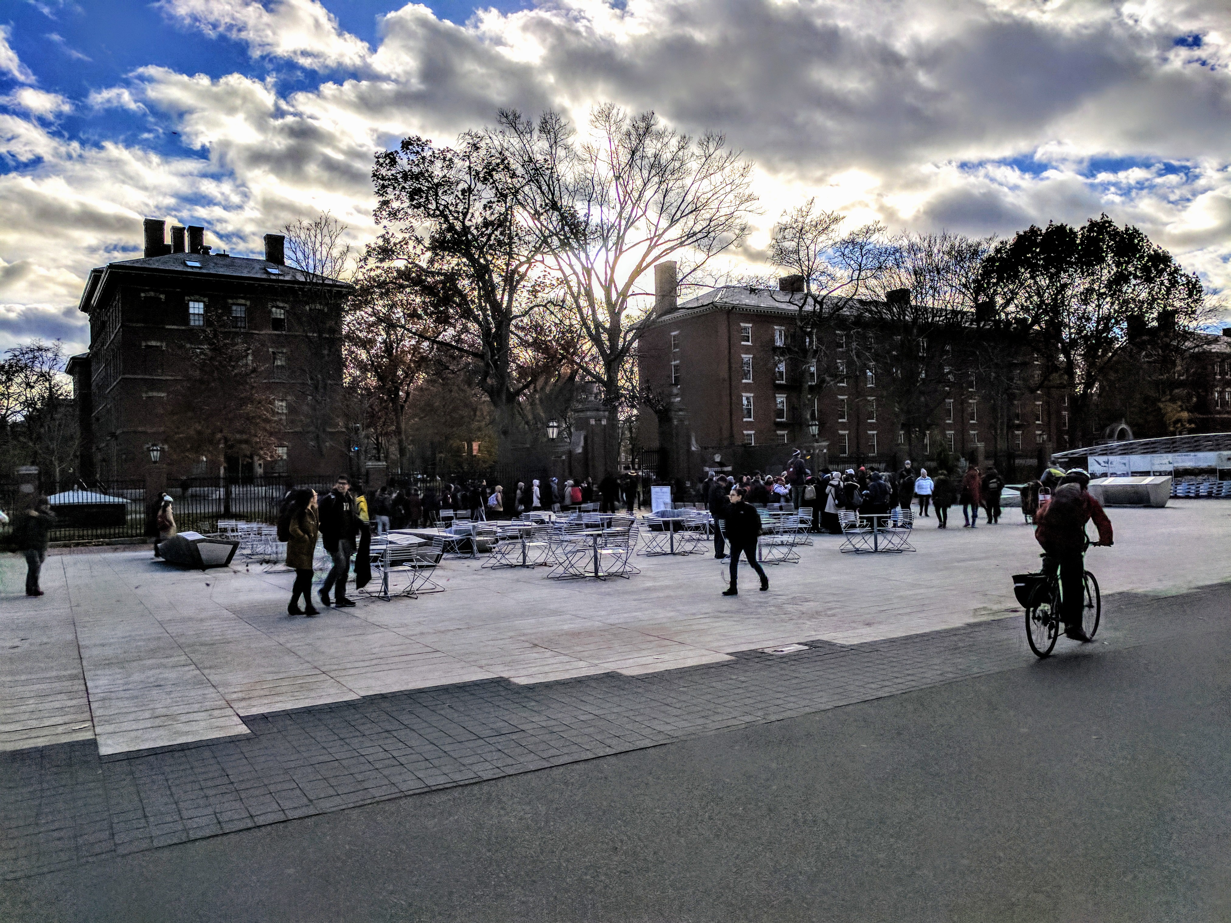 Outdoor photograph of Harvard Yard in the winter with blue sky and clouds.