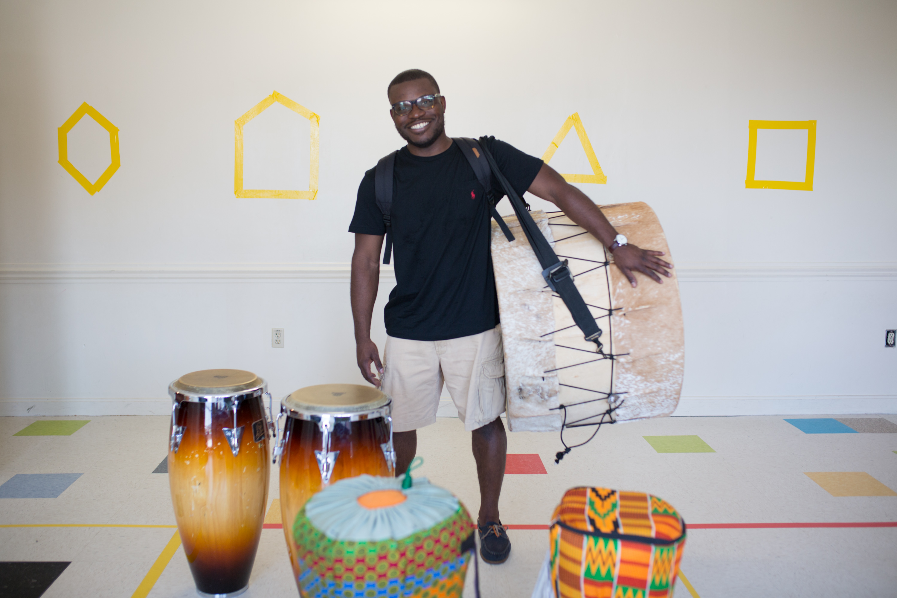 Jonathan Mande with five of his drums.