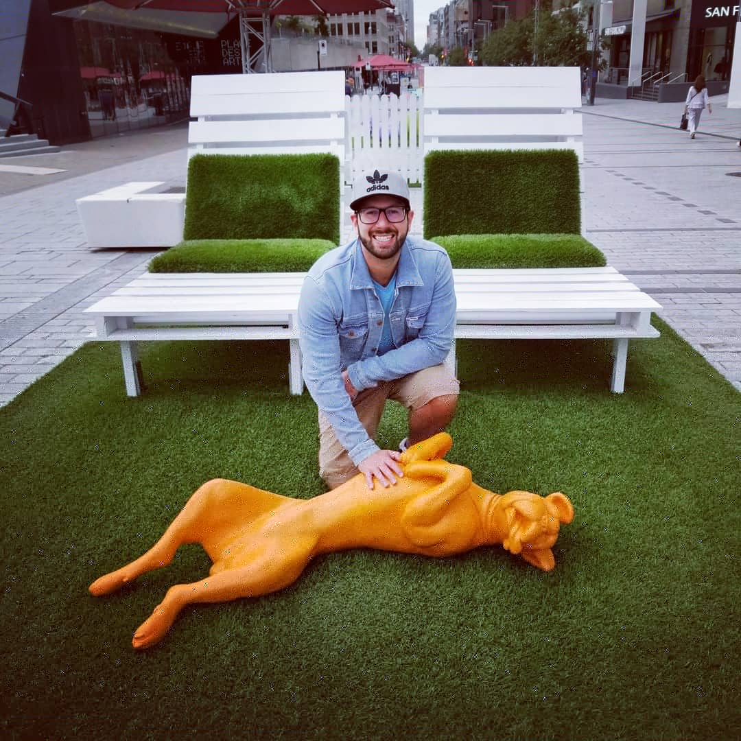Josh Pinker with a dog sculpture 