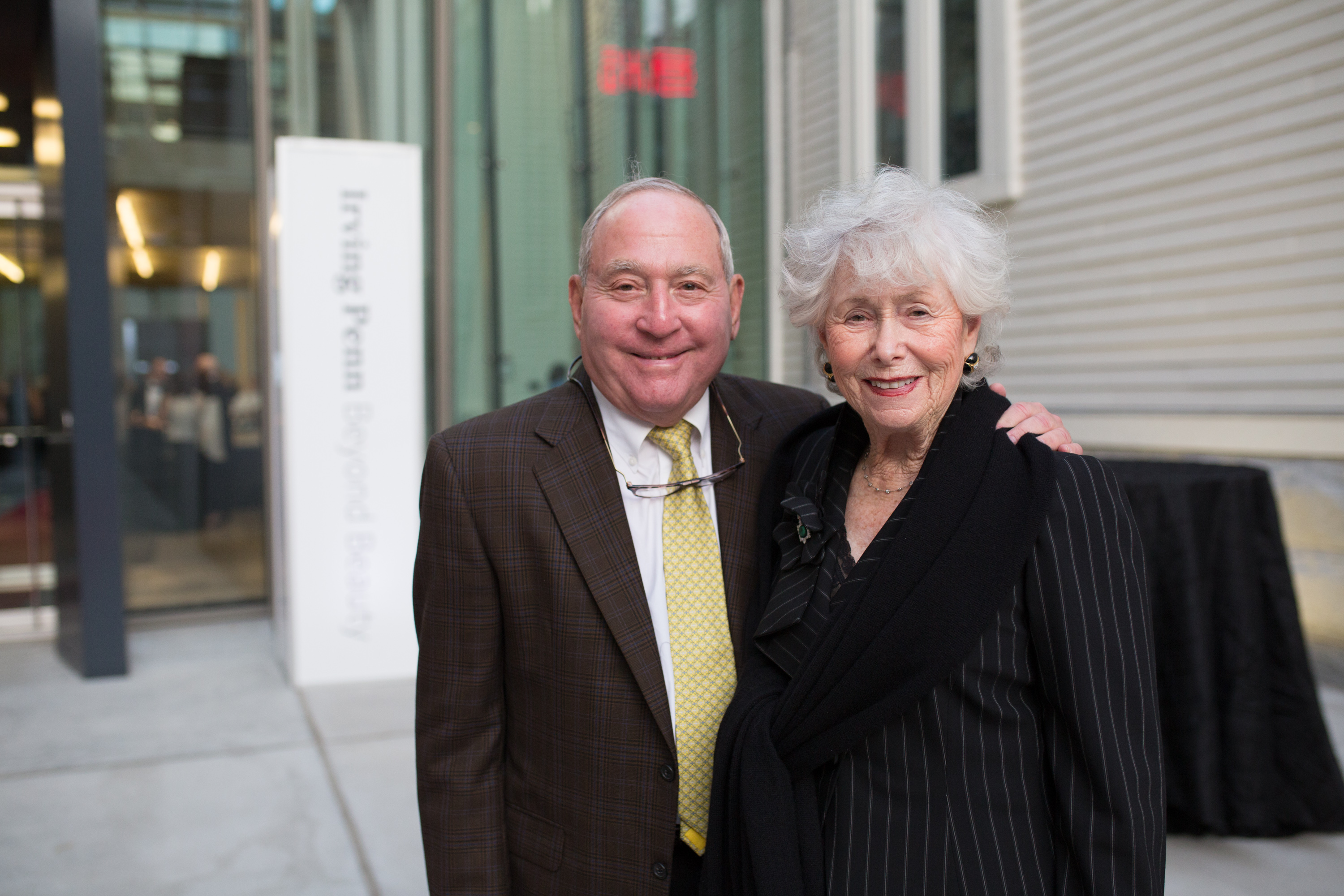 Peter and Paula Lunder pose in front of the Lunder Arts Center