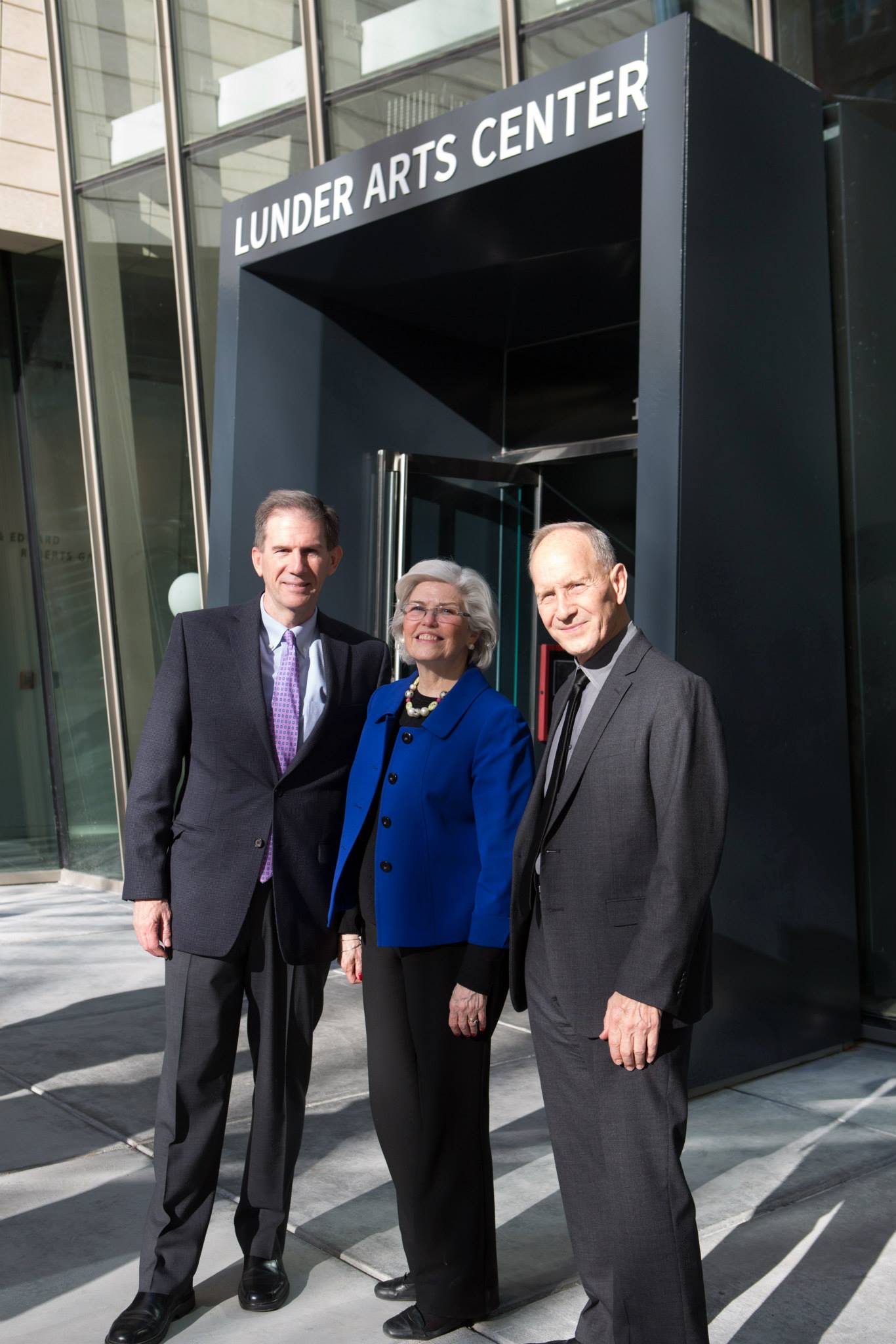 Joe Moore, Marylou Batt and Stan Trecker in front of the entrance to the Lunder Arts Center