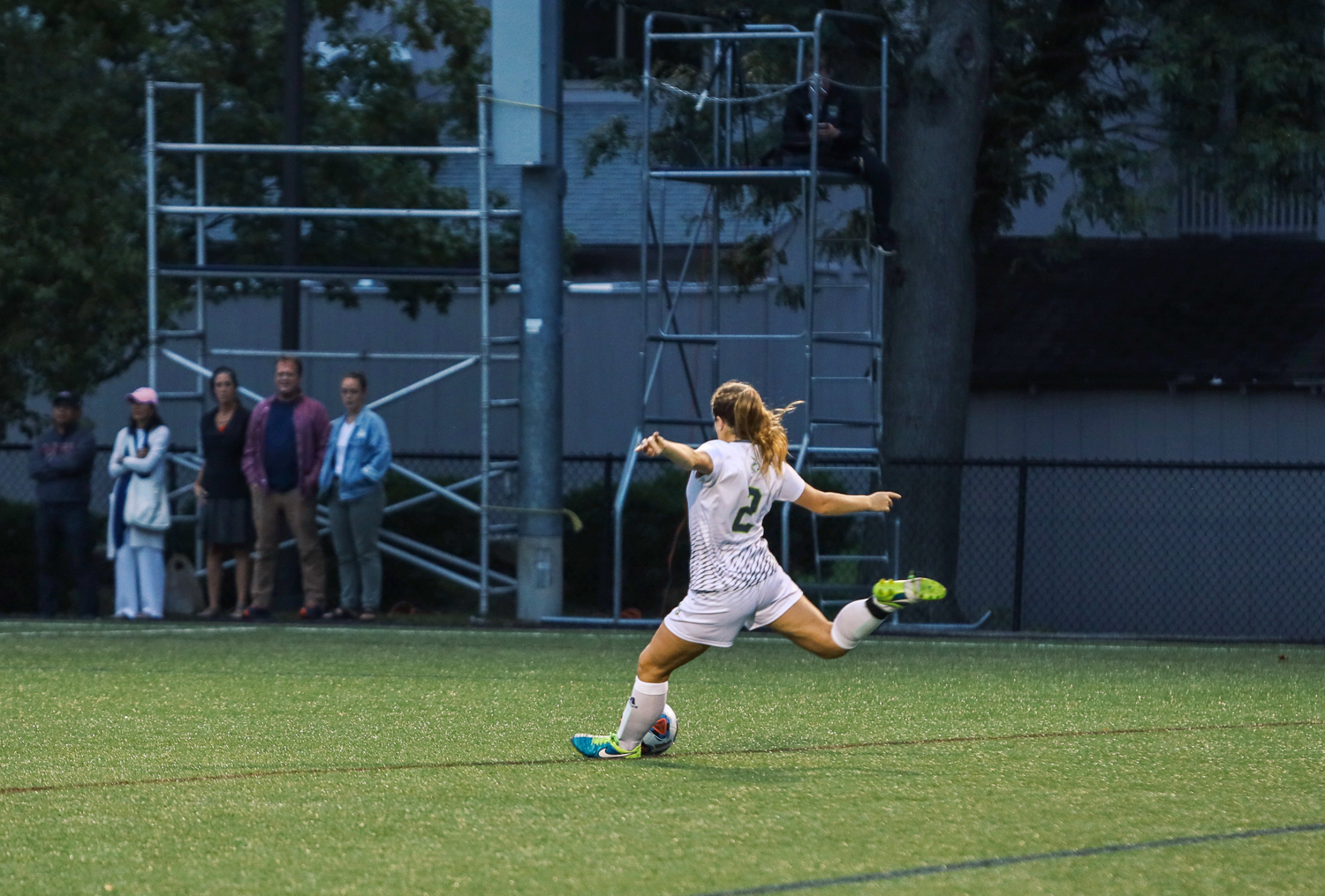 Melanie Mathewson on the soccer field kicking a ball