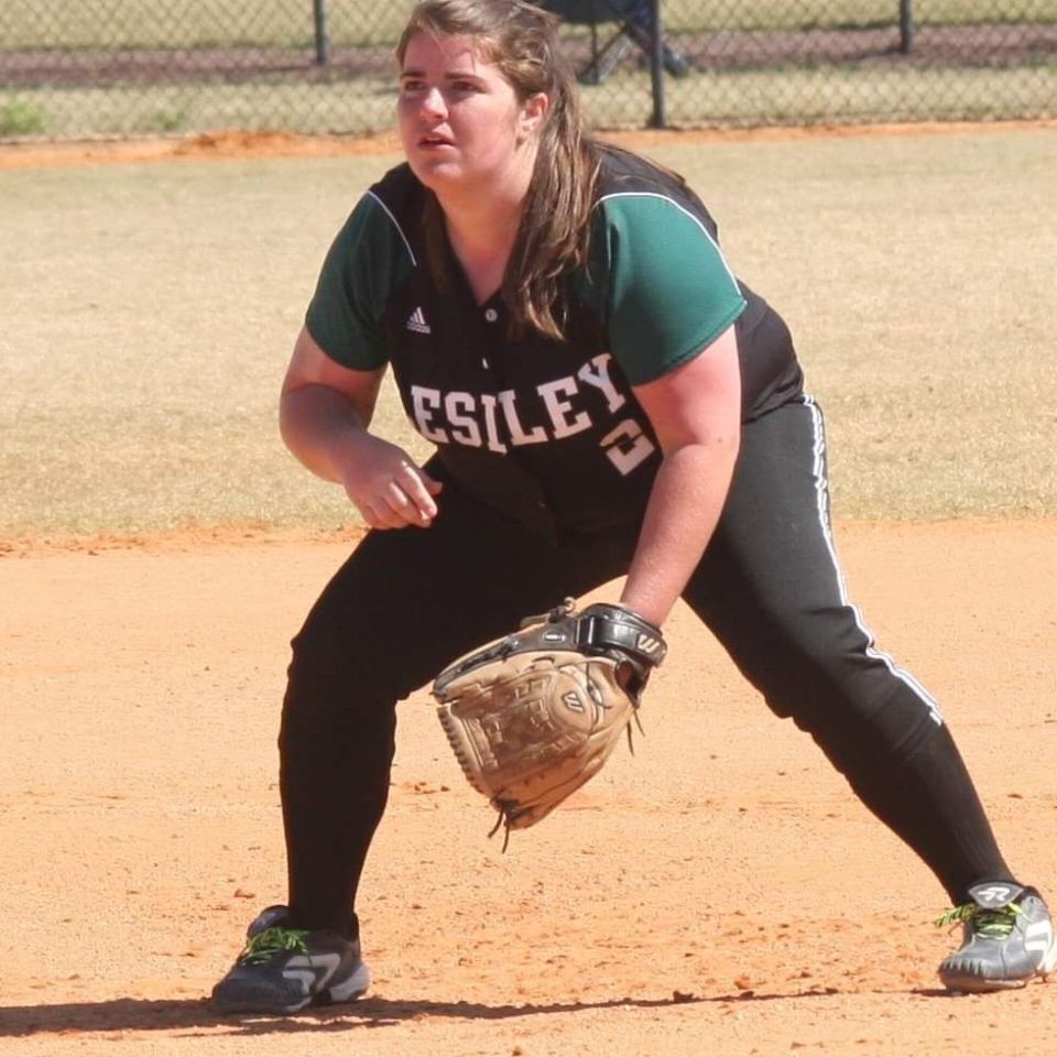 Molly Sarson playing softball for Lesley