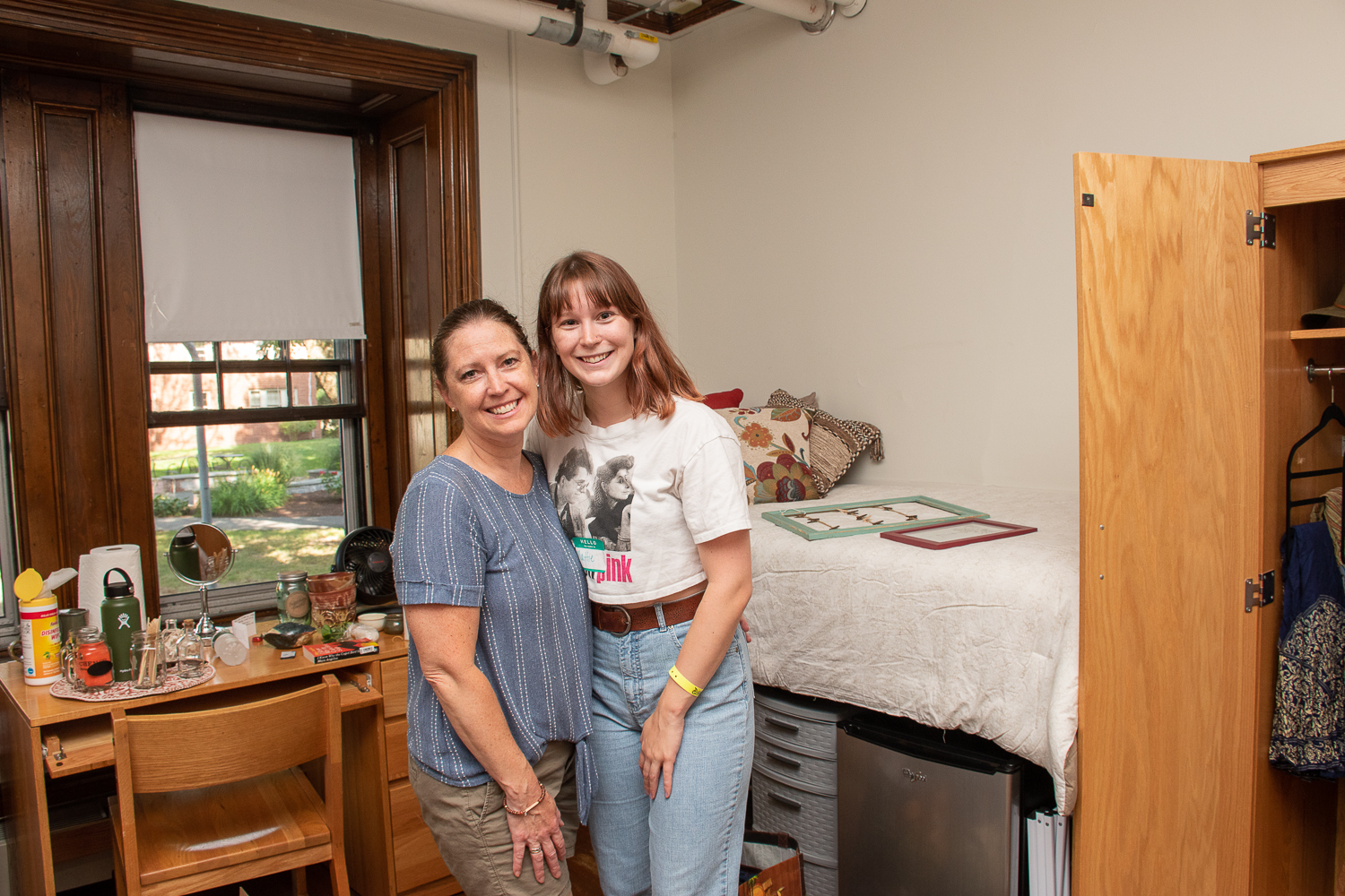 Mother and daugther in dorm room smiling