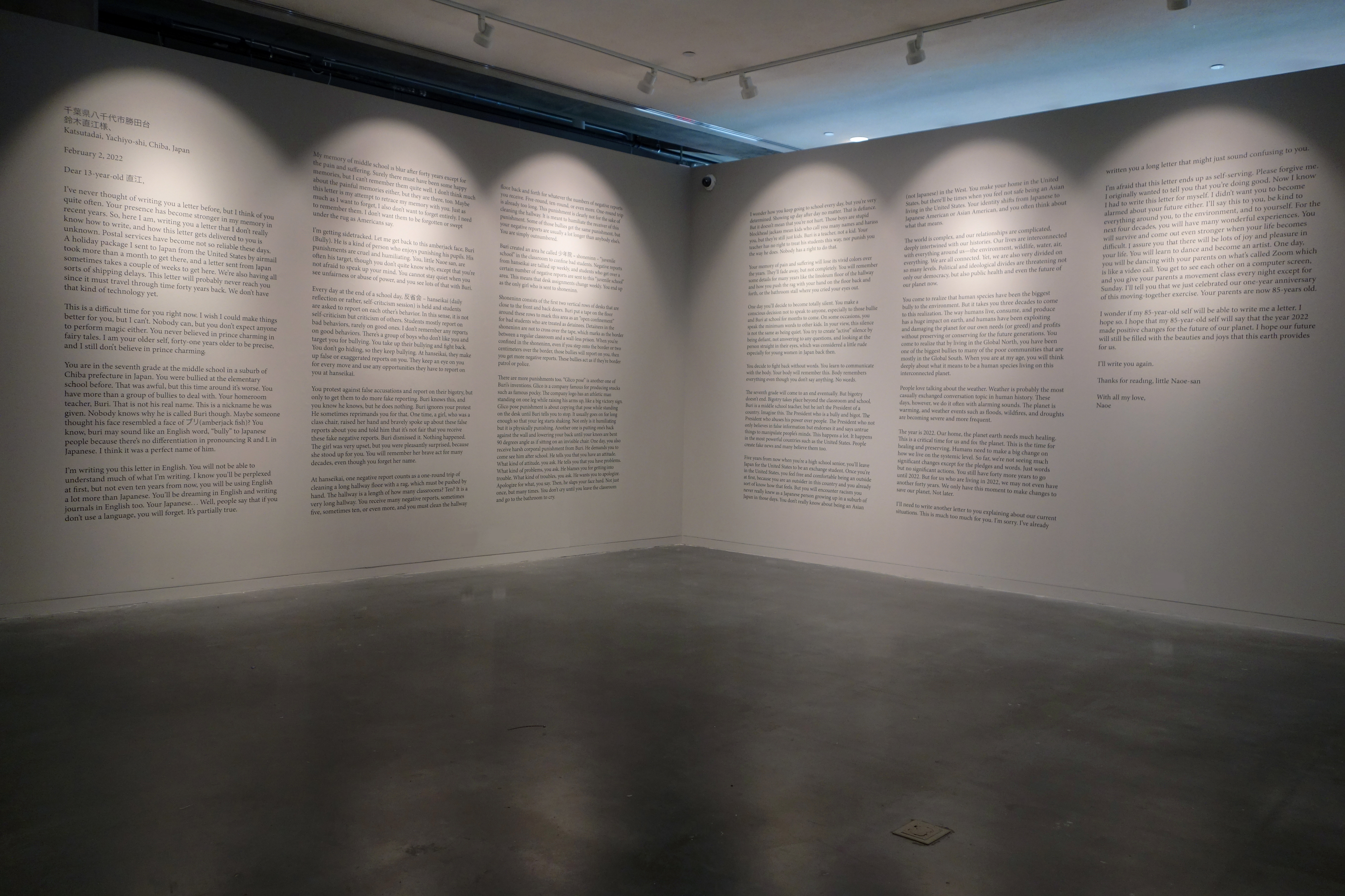 A photograph of gray wall covered in text. 