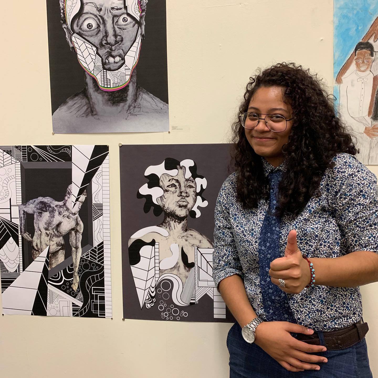 Natalia Reyes with her high school senior project - three black and white illustrations