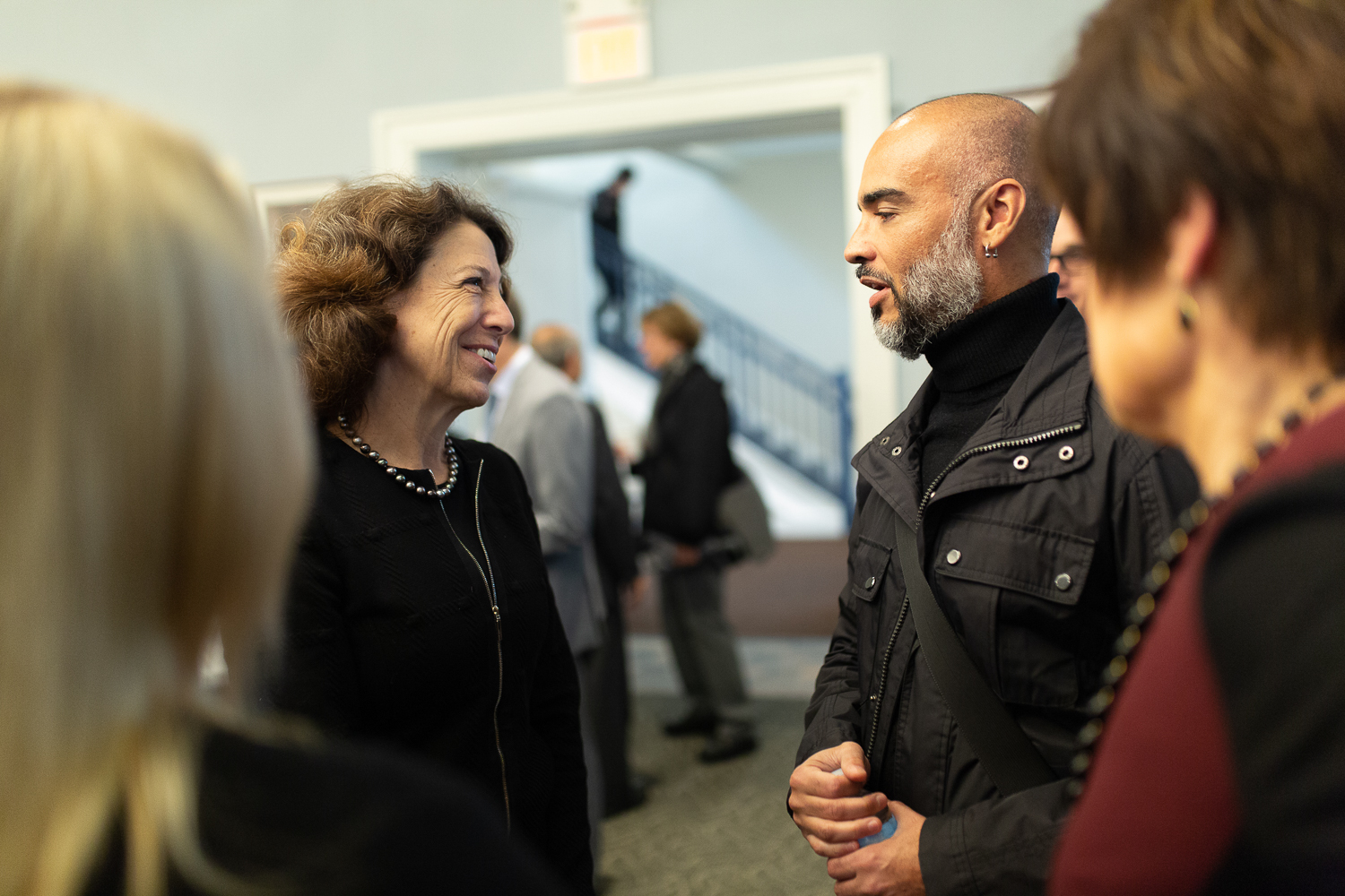 Janet Steinmayer speaks with faculty members.