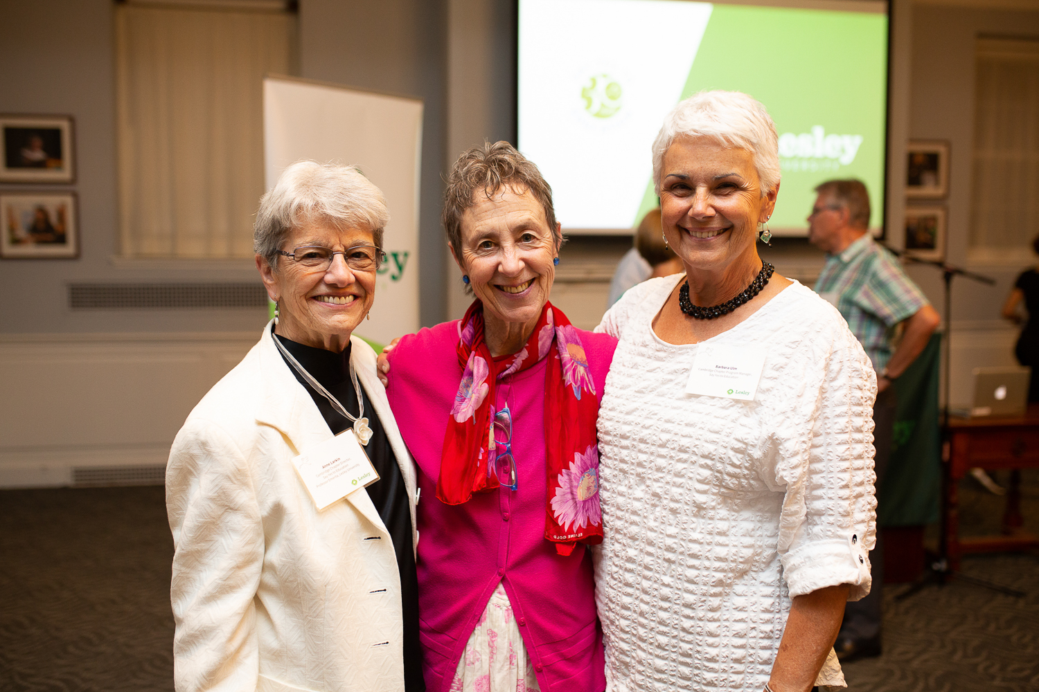 Three women smiling at the camera.