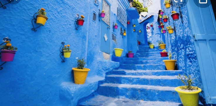An alley in Chefchaouen, the blue city in Morocco, steps and walls painted bright blue