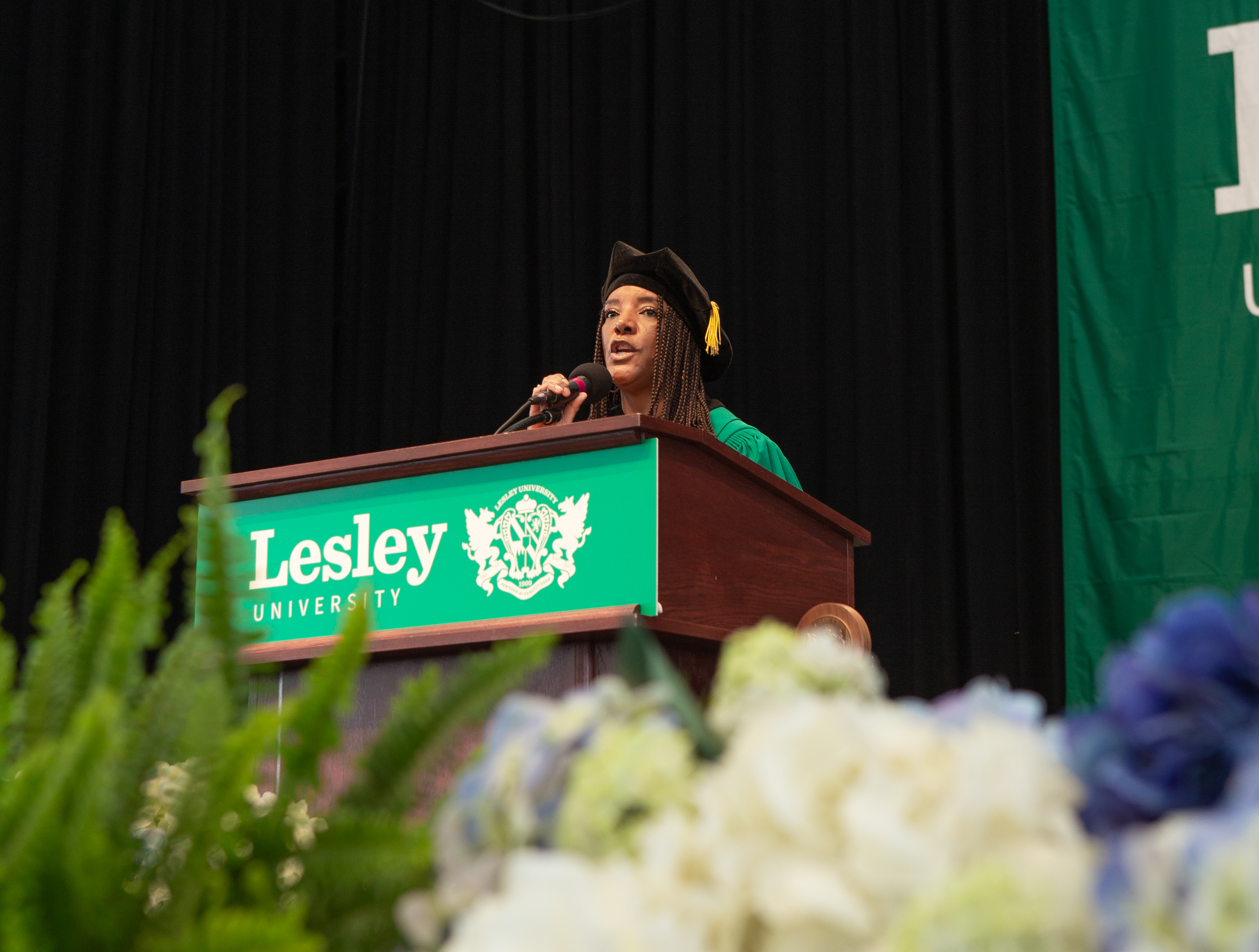 Anna-Maria Jones in regalia at podium