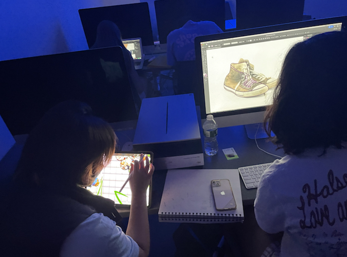 Students work on their sneaker designs.