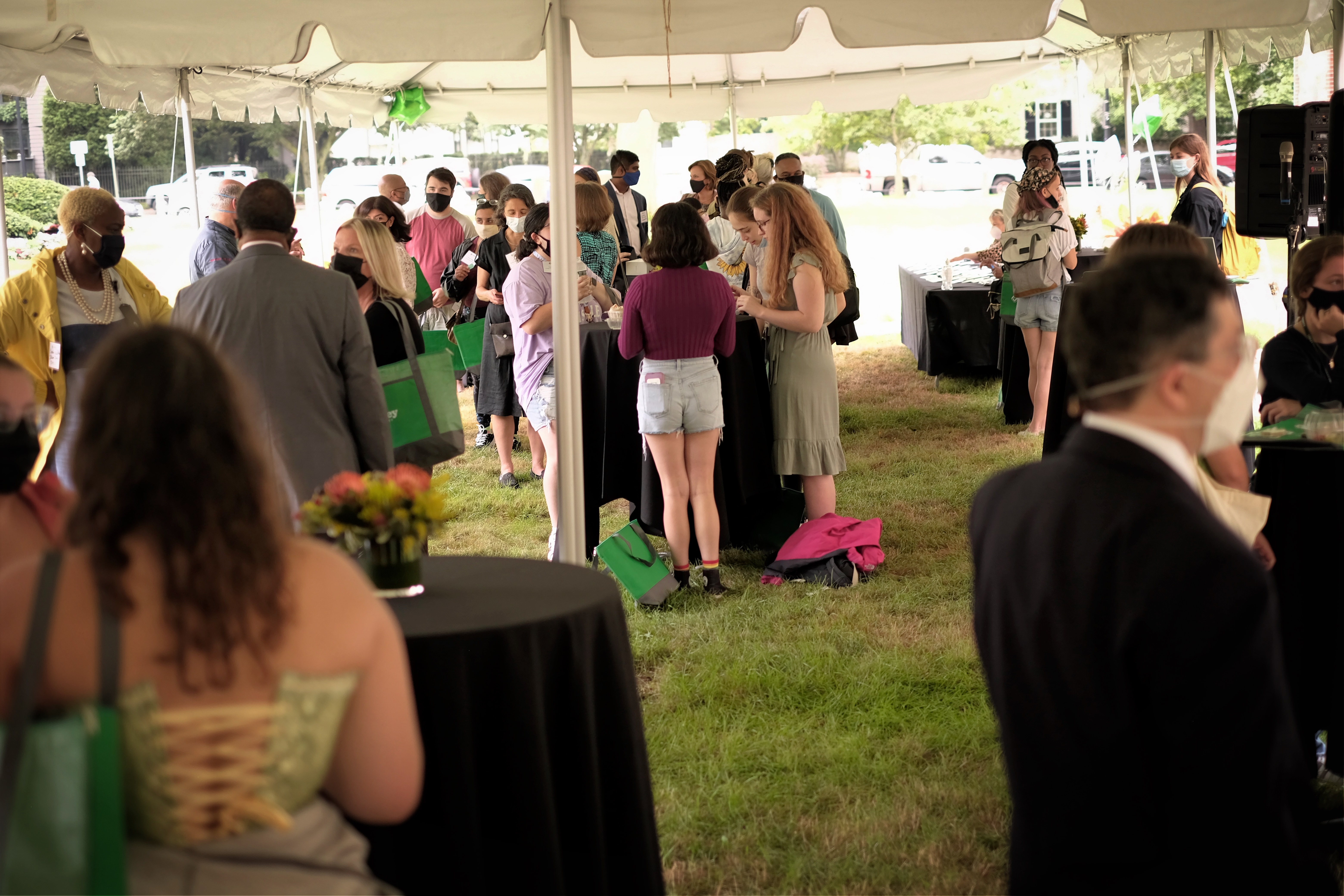 Large group of students gathered under reception tent