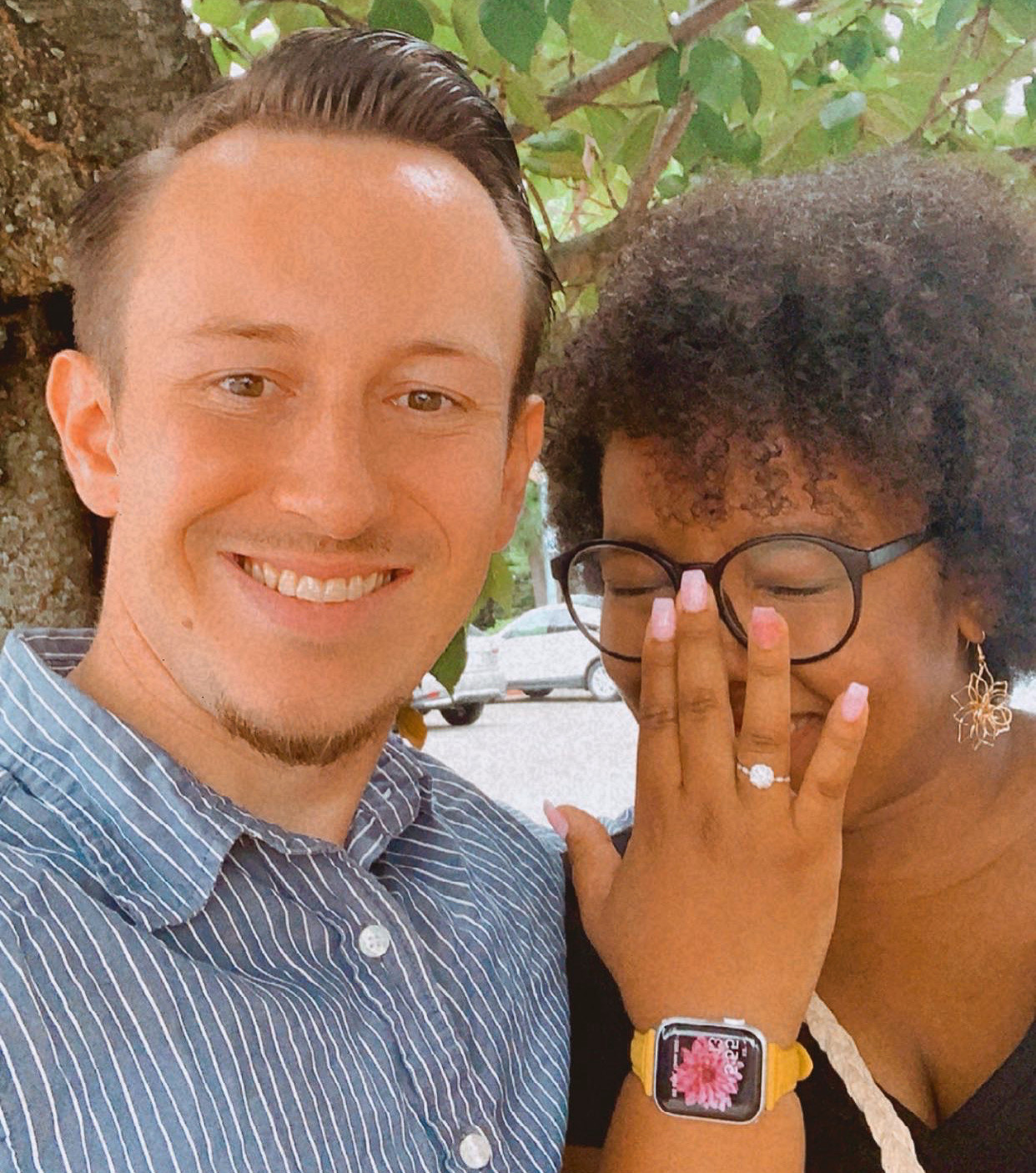 headshot of the newly engaged couple smiling.