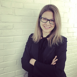 Heather Shaw leaning on a wall with arms crossed