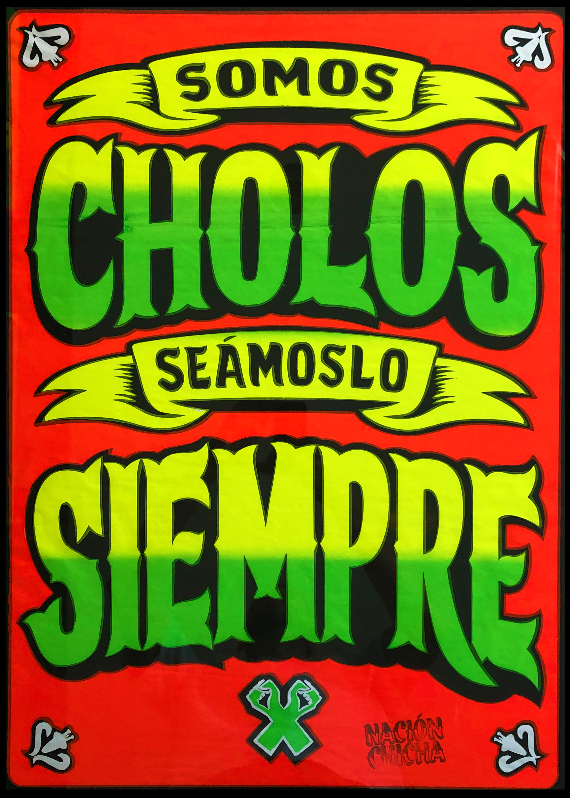 bright red poster with green and yellow block text that reads "SOMOS CHOLOS. SEAMOSLO SIEMPRE"