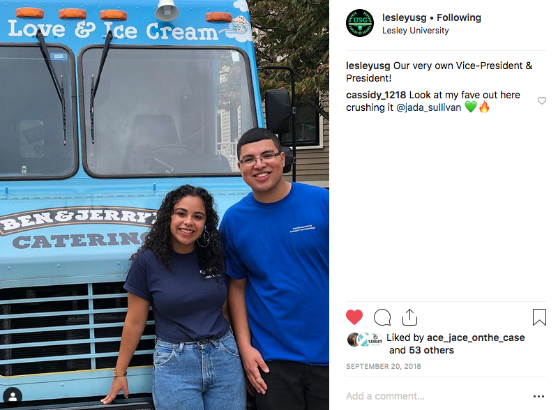 Photograph of the student government president and vice president standing in front of a Ben and Jerry's ice cream truck.
