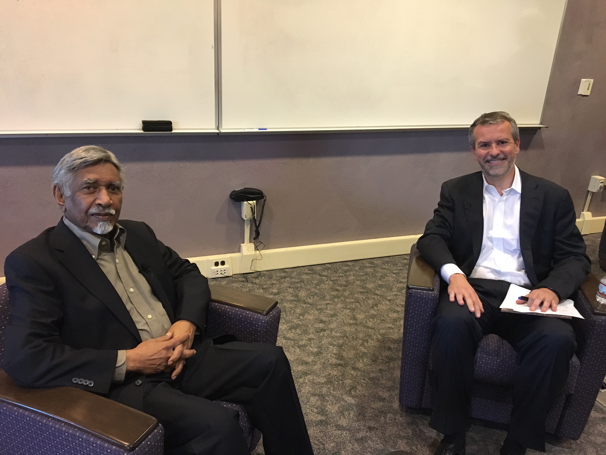 Mac Maharaj seated in Sherrill Library with moderator Roger Berry