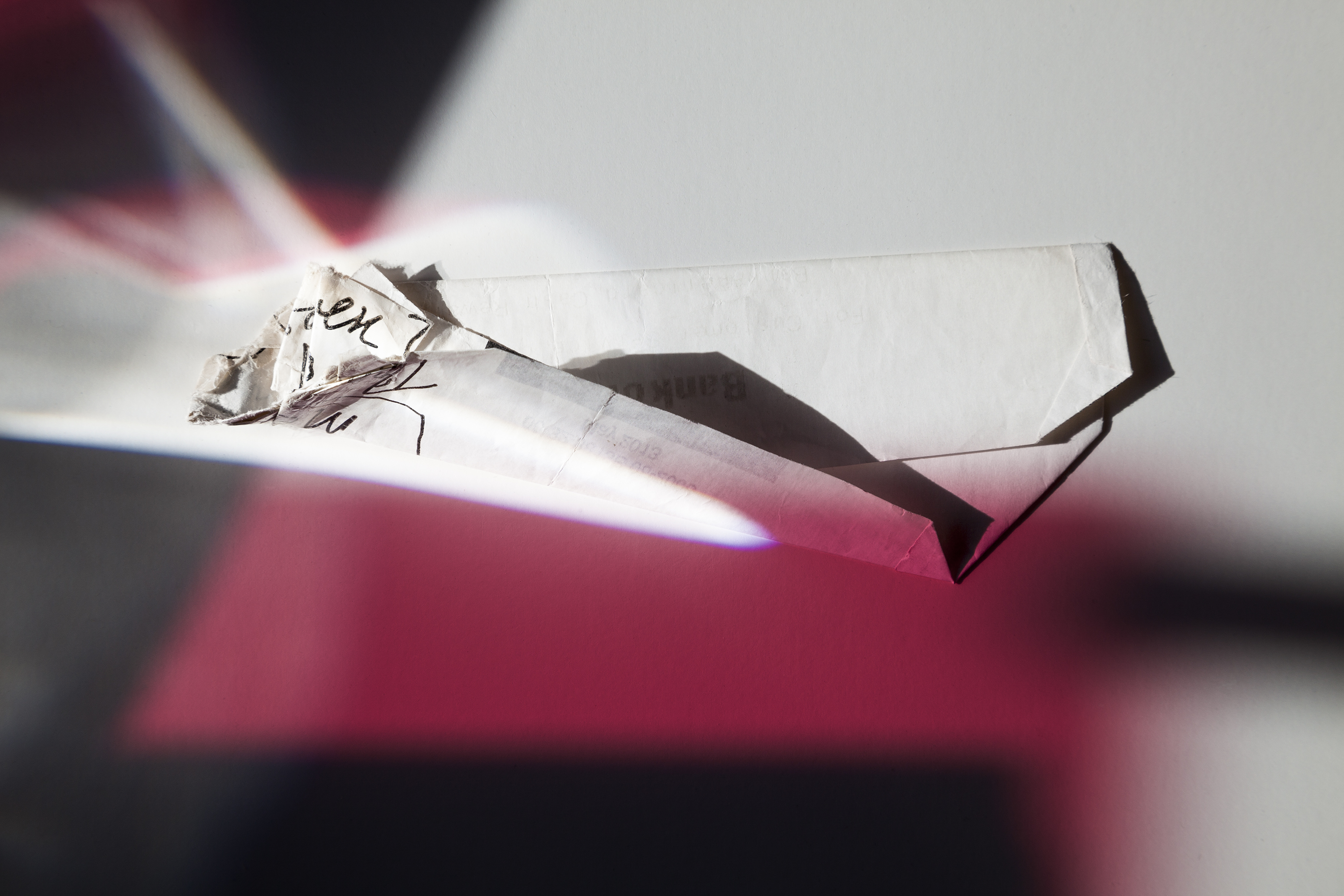 photograph of crumpled paper illuminated under red and white light.