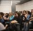 students listen to a presentation in screening room