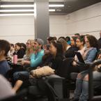 students listen to a presentation in screening room