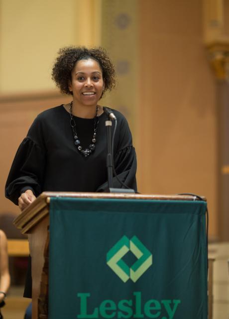 Maritsa Barros speaks at a podium in the church.