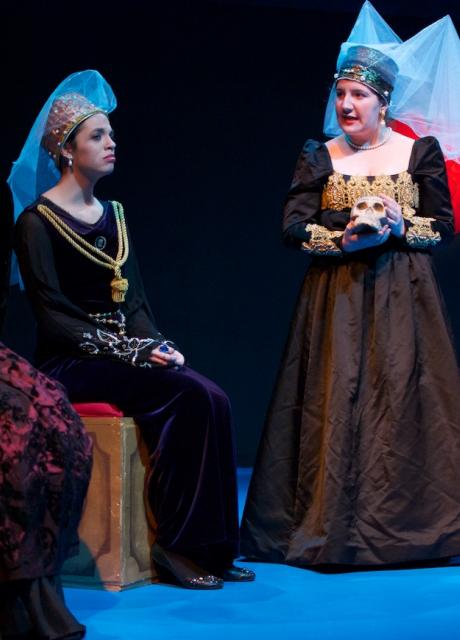 student actors in cloaks on stage in a Shakespeare play