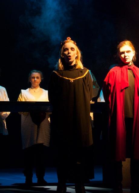 students in cloaks acting in a Shakespeare play