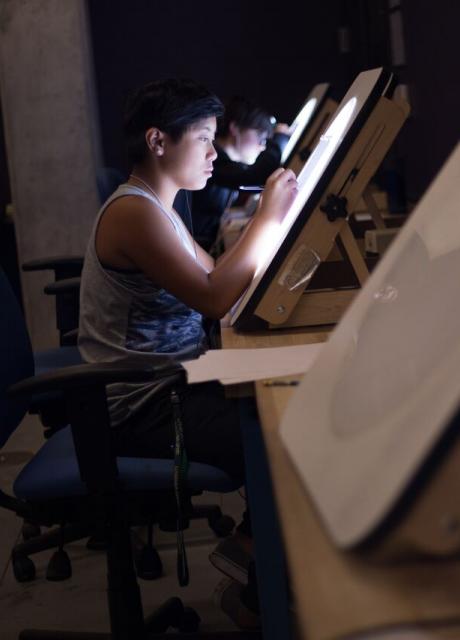 student drawing on lightbox in drawing studio