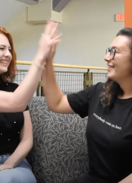 upperclassmen high-fiving during video