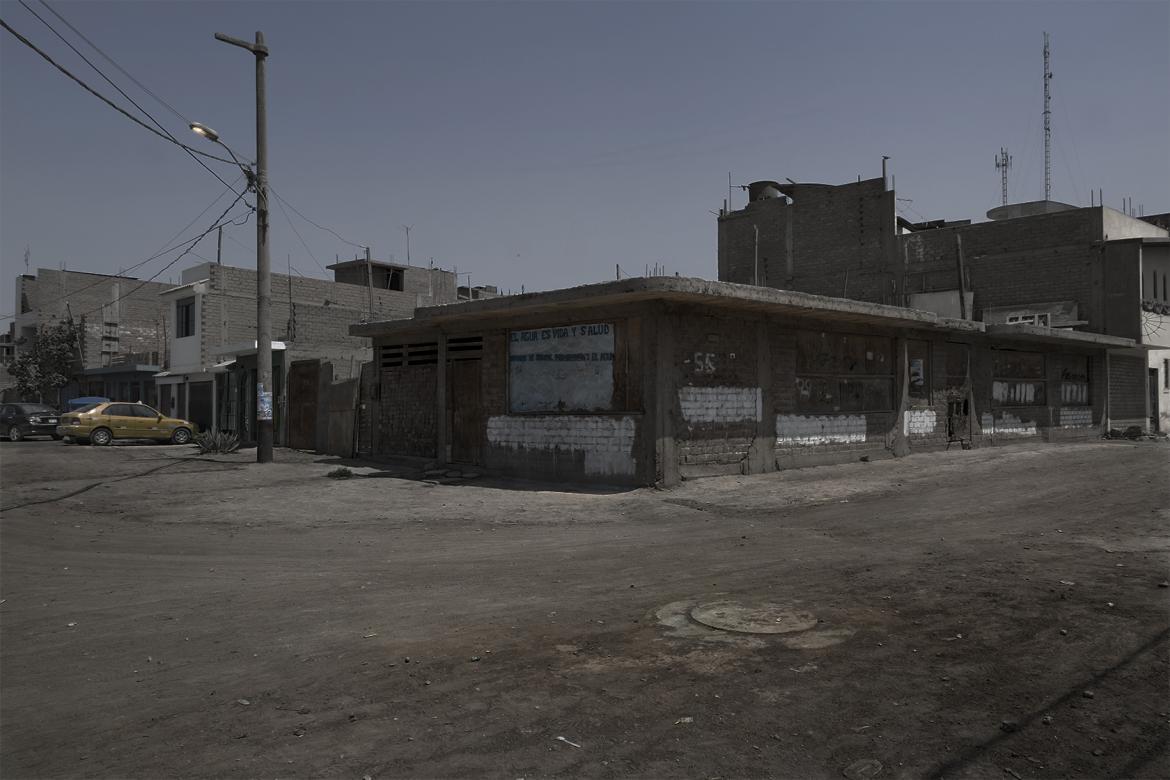 photograph outside of run-down building with clear blue sky in background